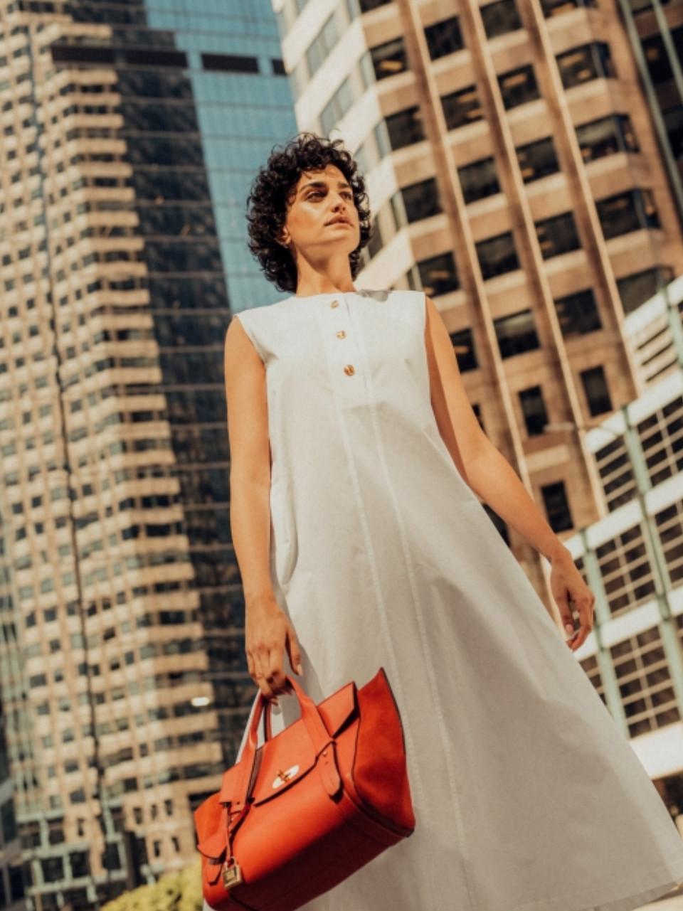 Woman in premium fashion photographed in warm natural light