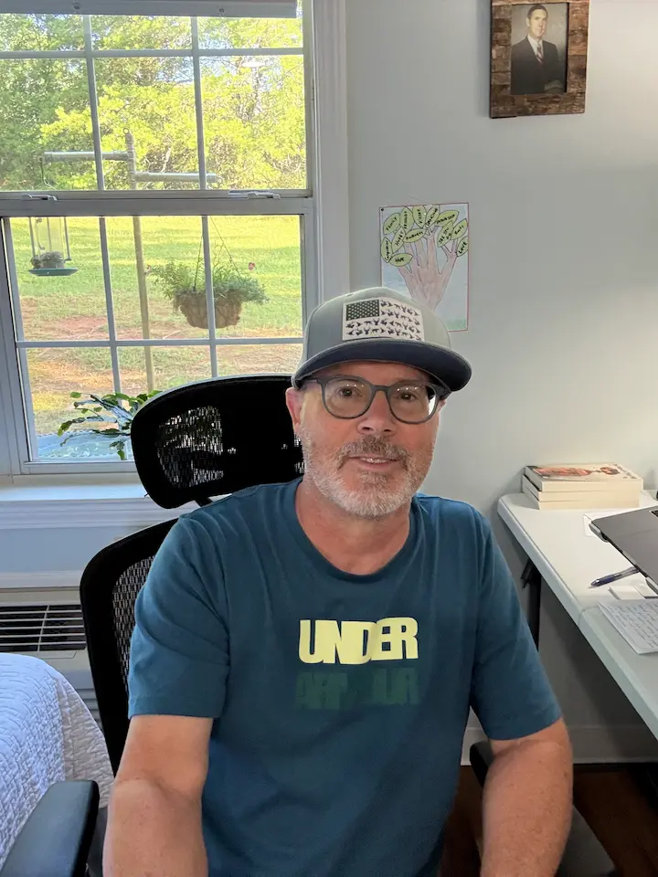 Stuart Simpson smiling at his desk reflecting on the journey that led to the newly revised second edition of his book.