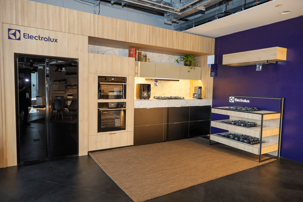 Group of smart speakers with glowing tops, set against a dark, starry background.