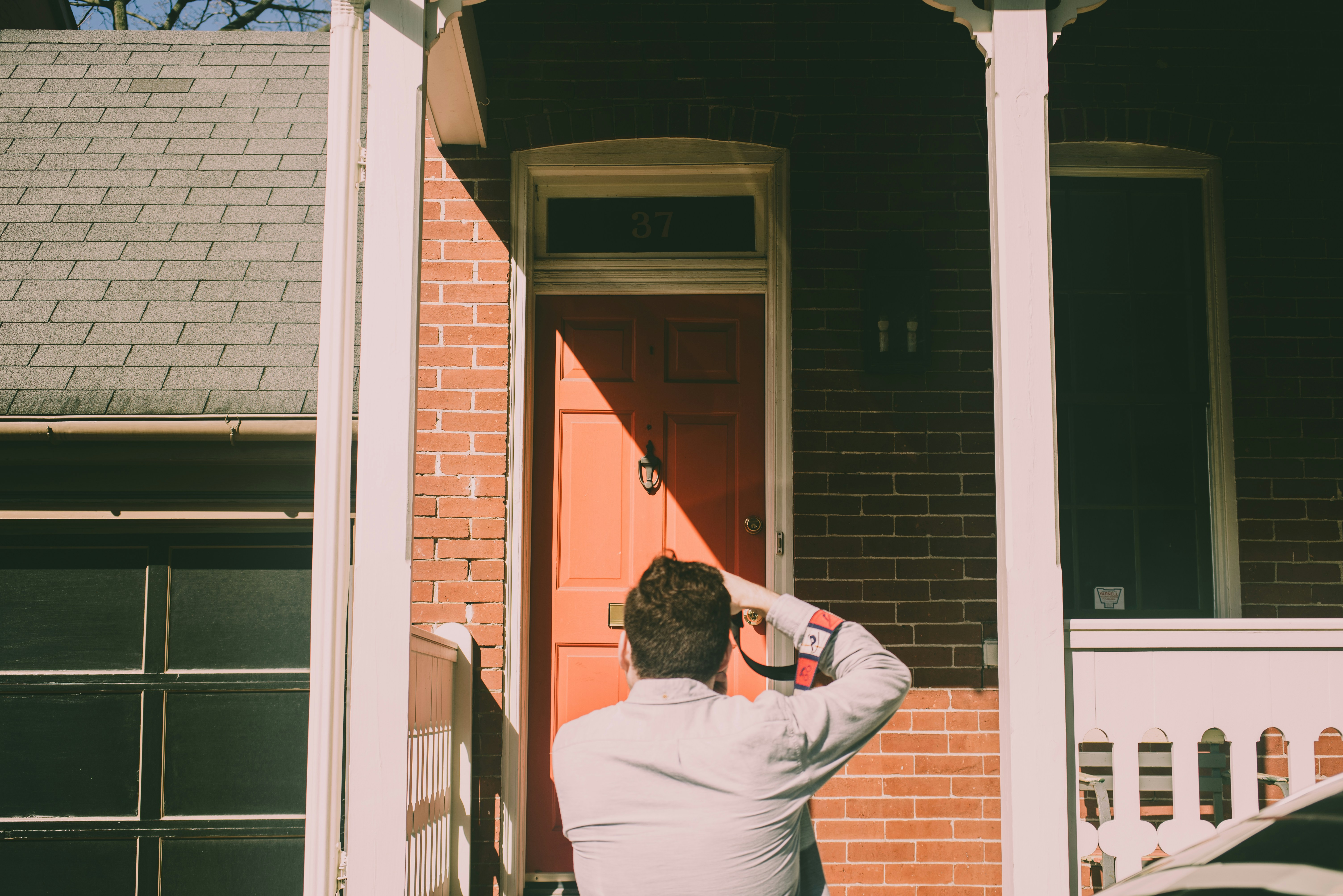 a person standing in front of a red door
