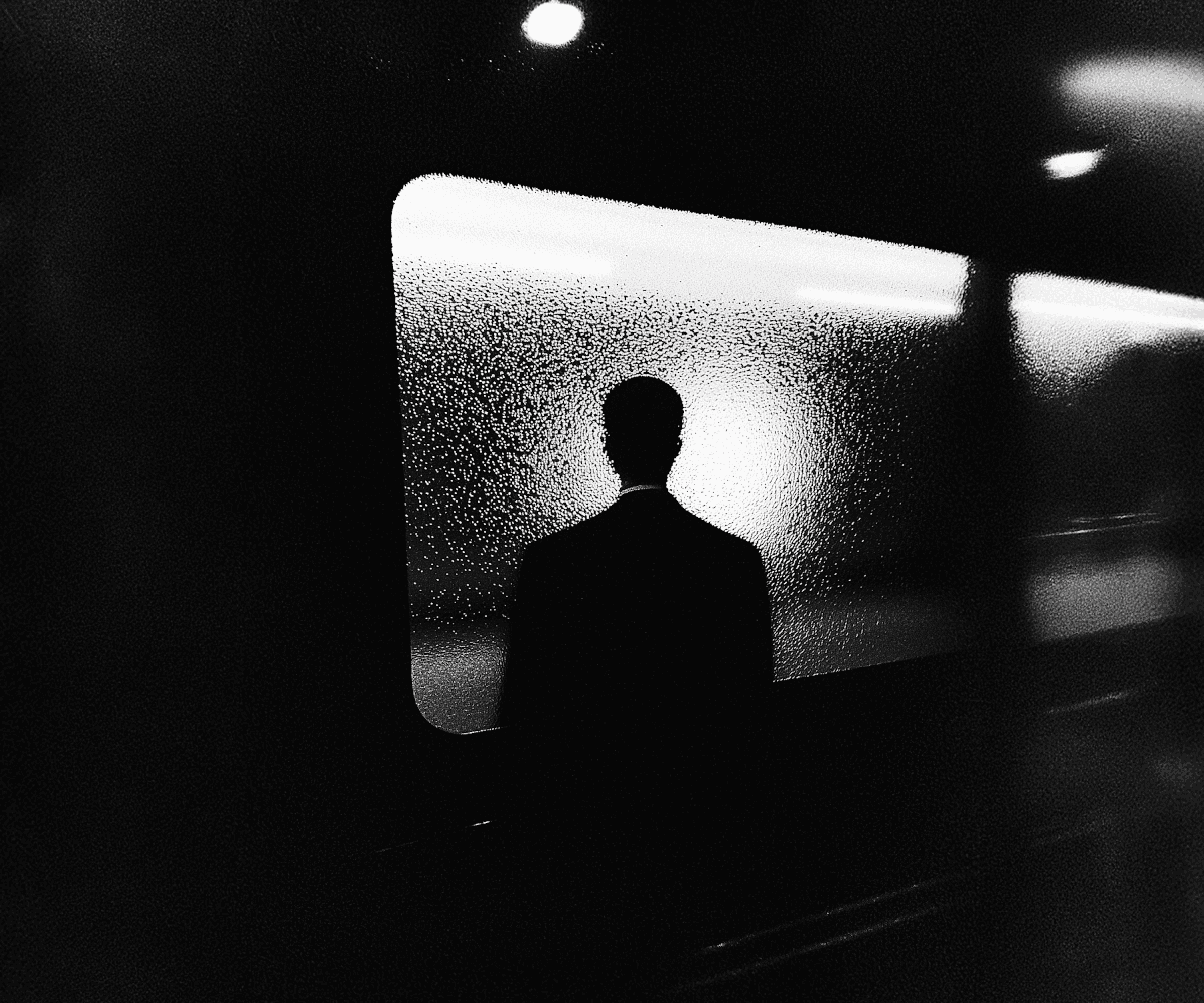 Person standing before frosted glass in darkness — metaphor for founders unable to see the real cause behind low conversion rates and user drop-off