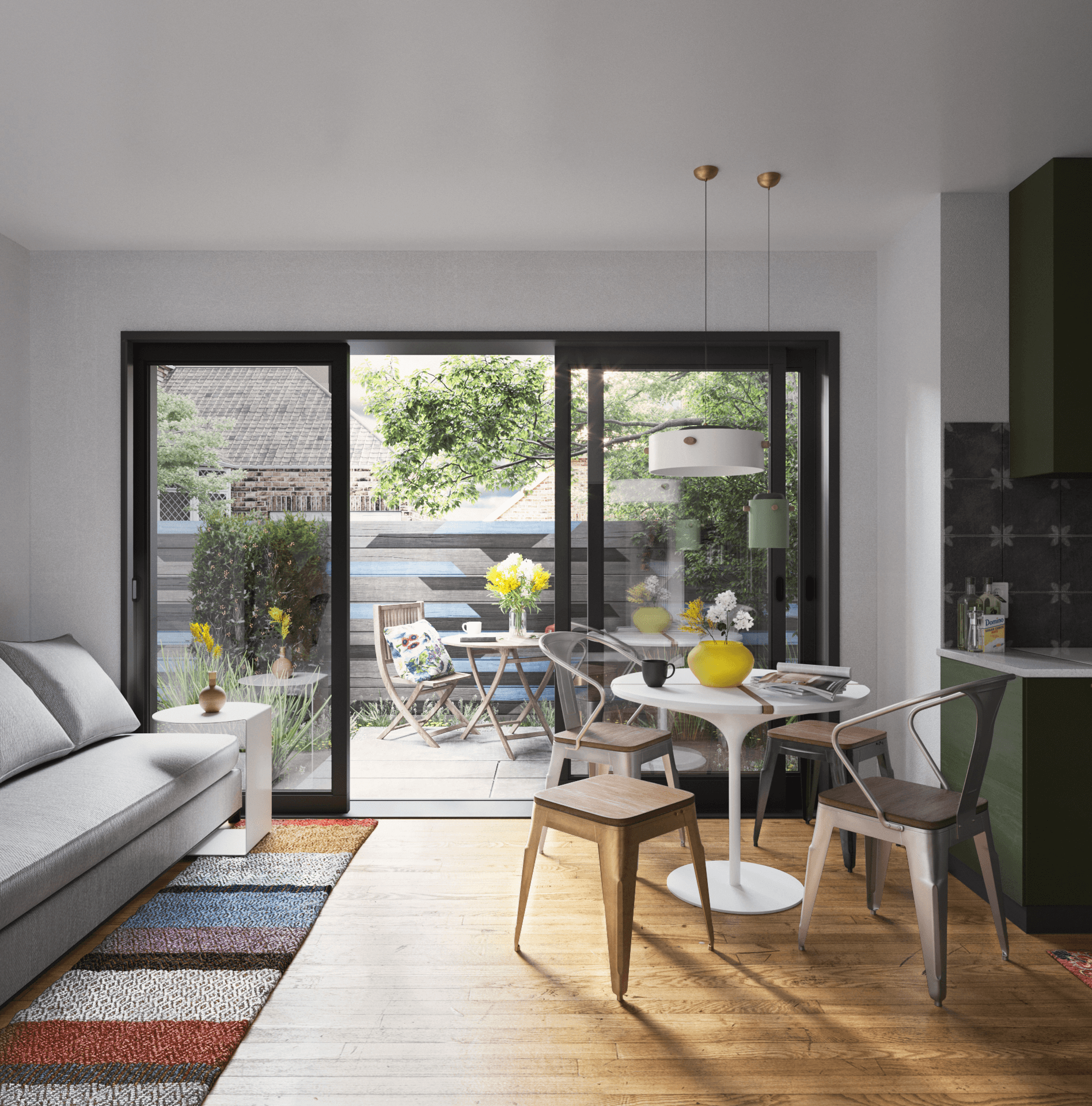 A spacious industrial-style interior with exposed brick walls, large windows, and natural light pouring in during sunset. Wooden desks with plants and workspace materials are arranged along the walls, with a view of greenery and an outdoor seating area.