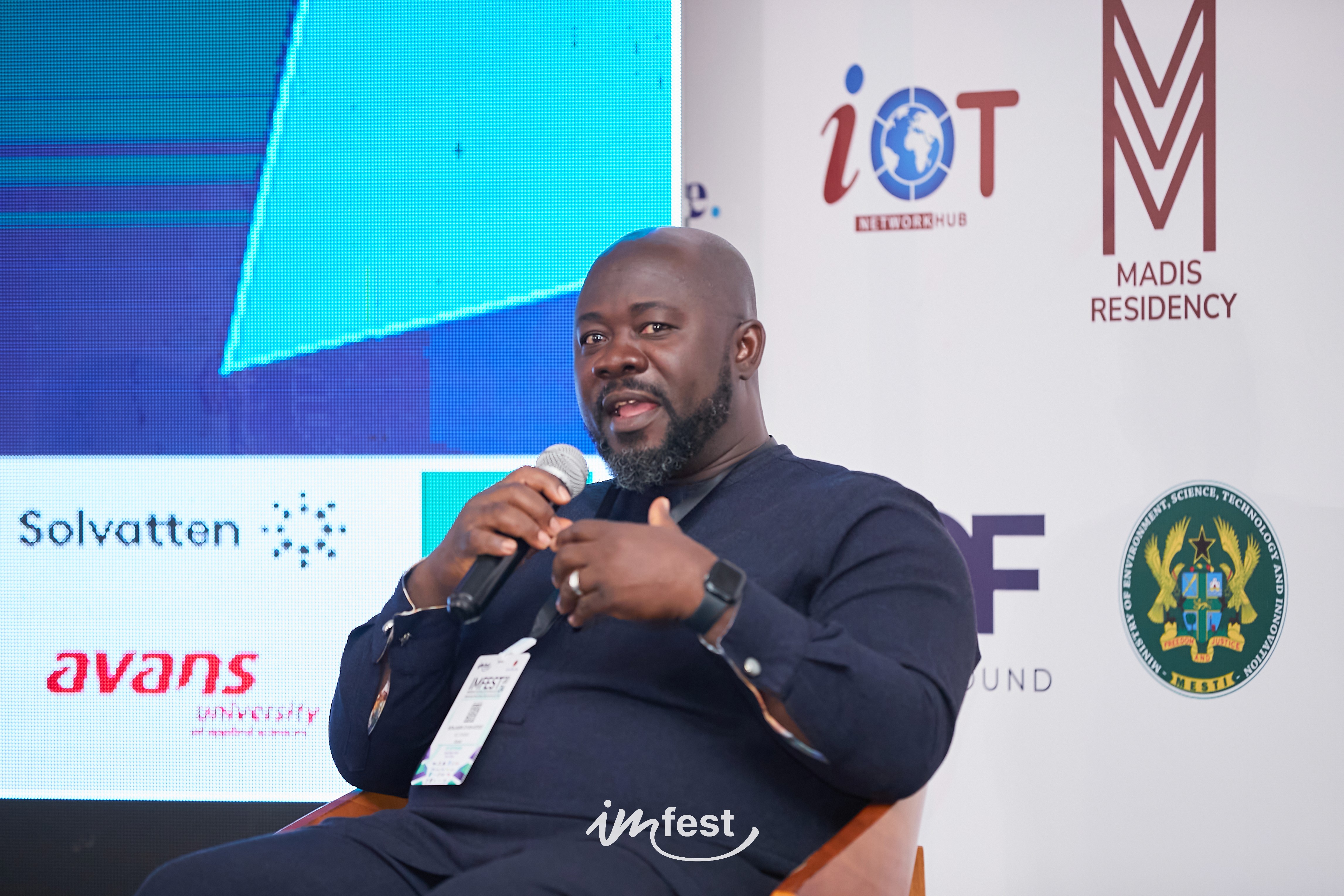 An orange cube-shaped side table is shown.