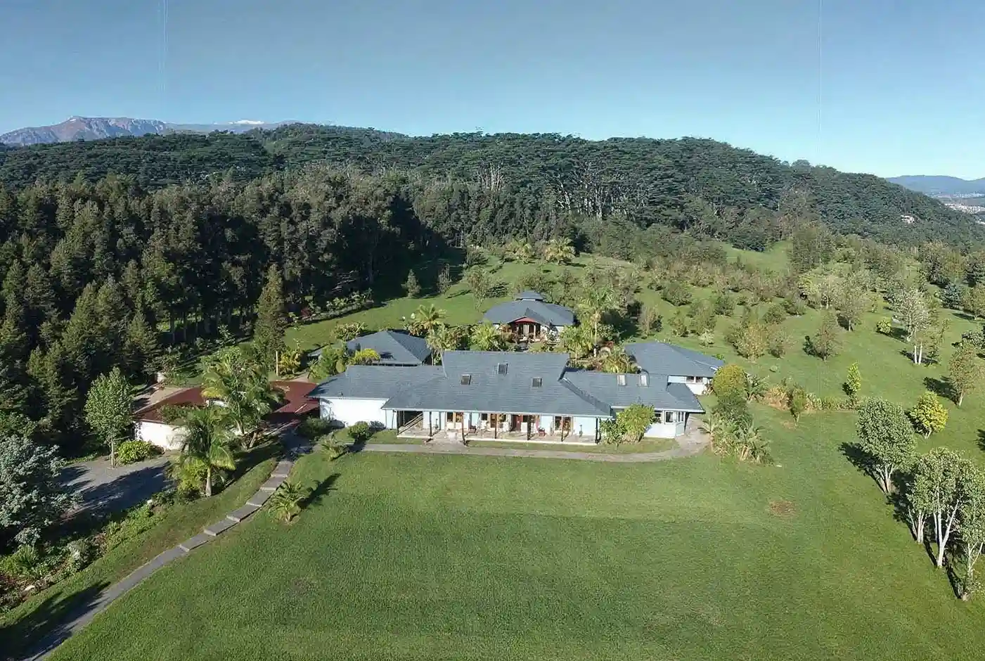 Aerial view of Kahuna Falls retreat estate with main lodge and lush Hawaiian landscape