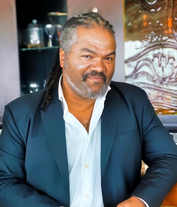 Dave Crane speaking on stage, inspiring leaders to grow.