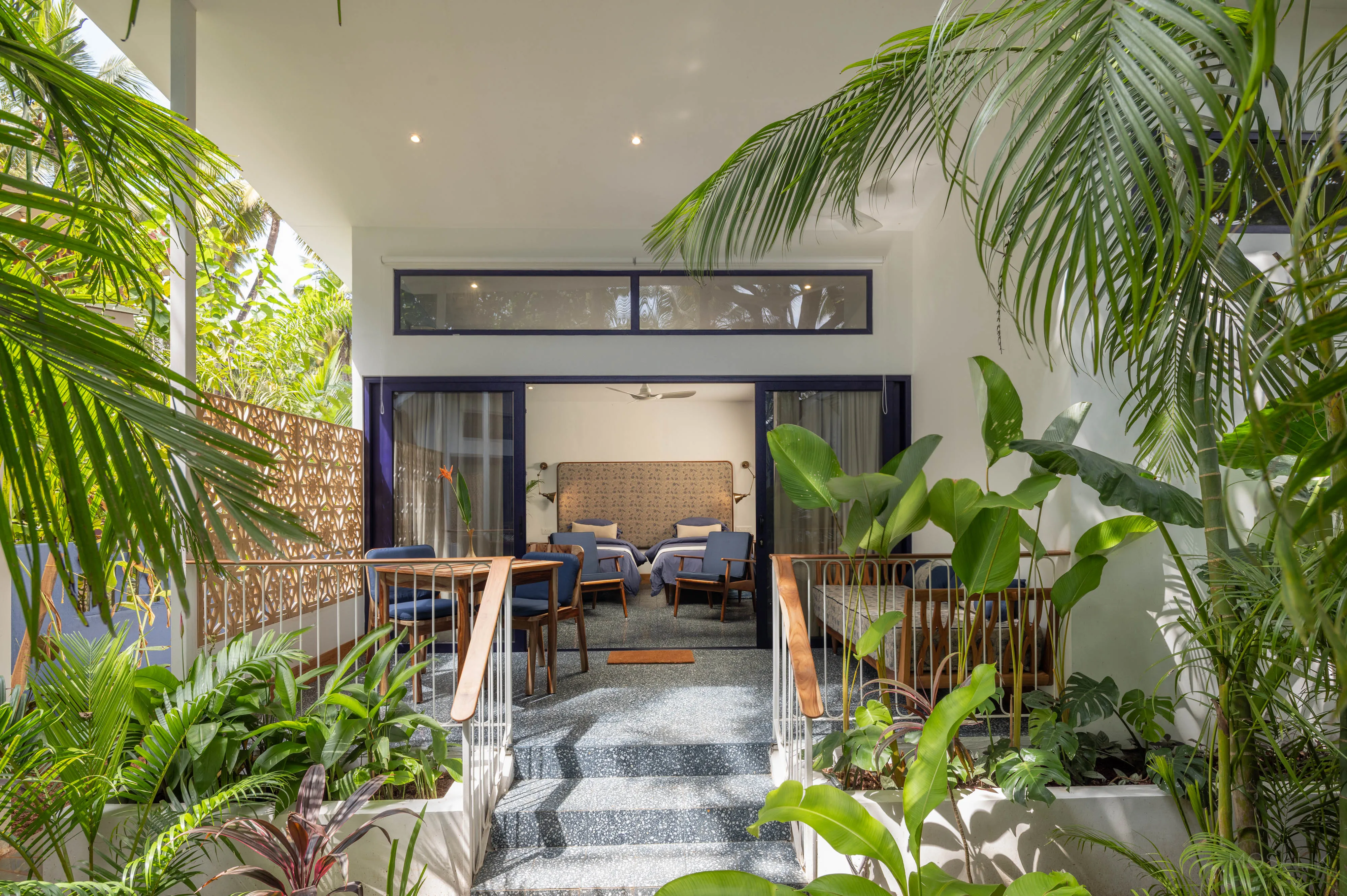 Bedroom framed in banana palms at Jaali Blue