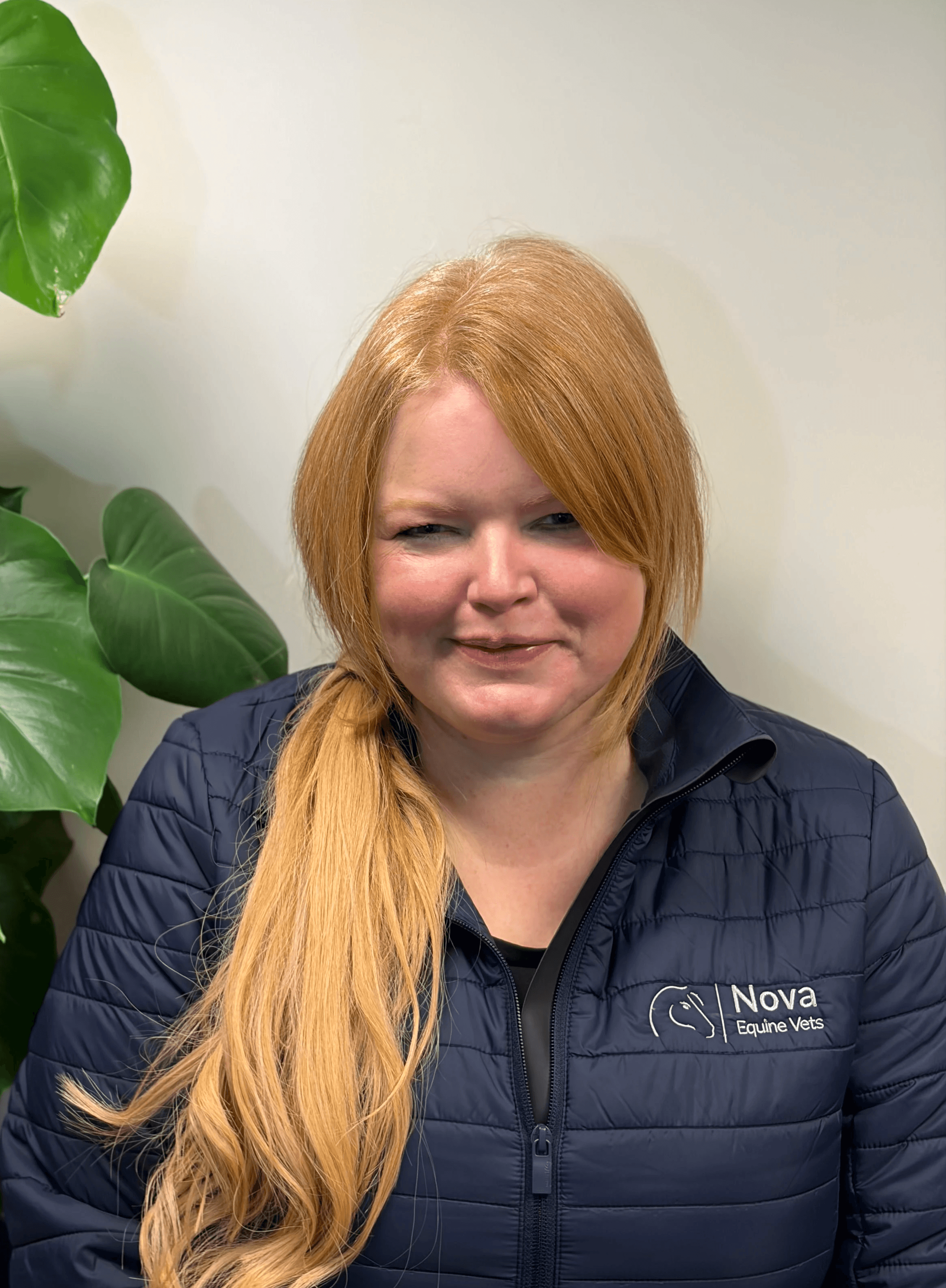 a man in a blue shirt smiling at the camera