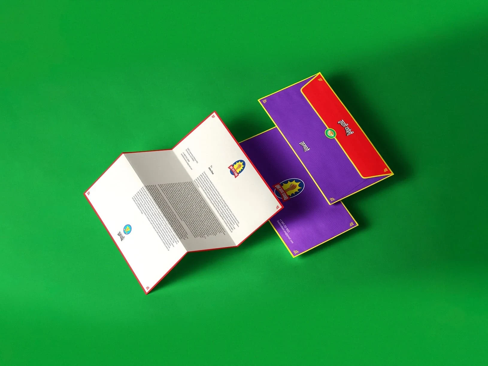An open white-and-purple booklet with red-and-yellow trim and printed text lies diagonally on a bright green background, casting a shadow.