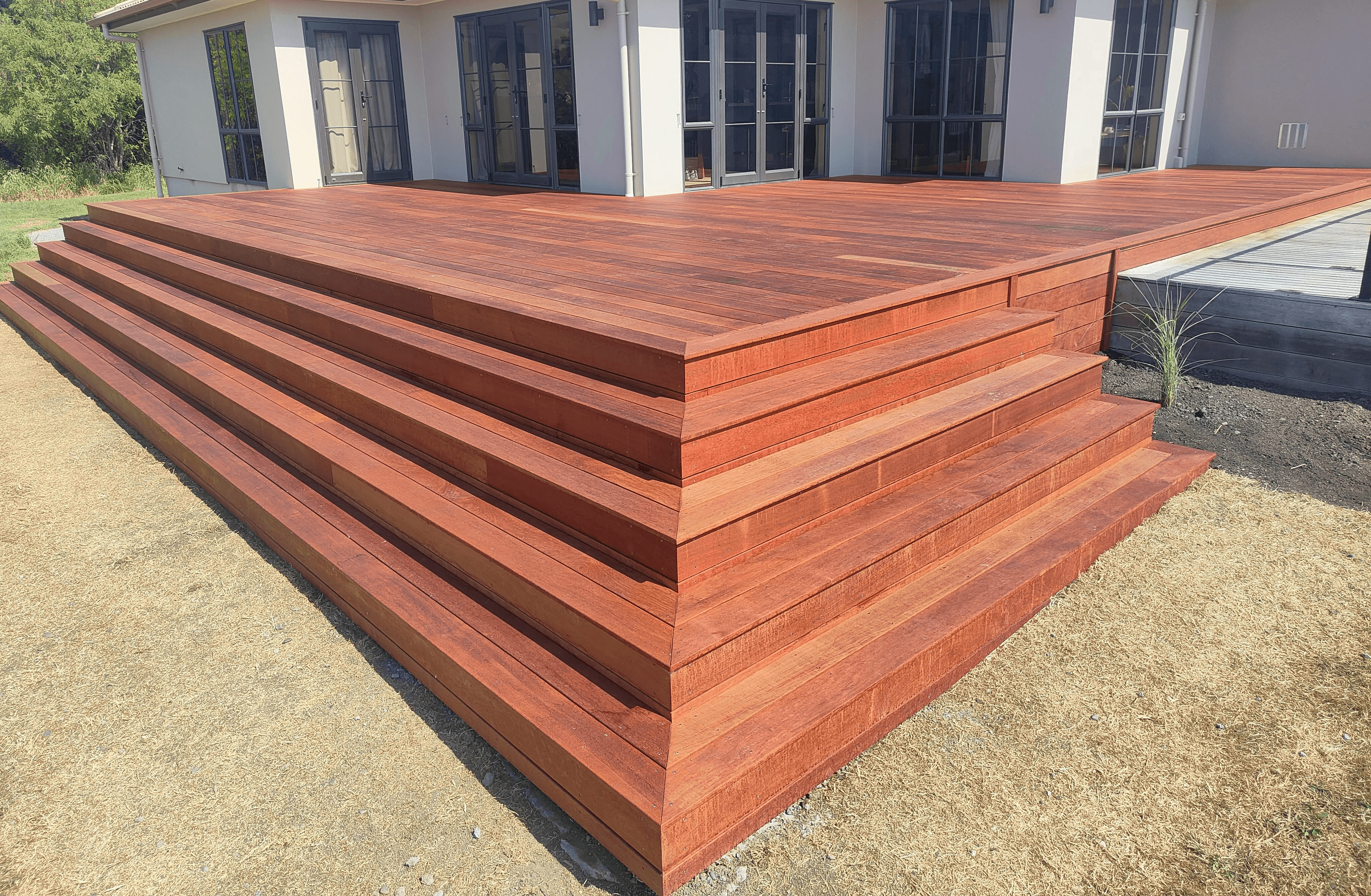 Kwila deck built by Zenbuild, Hawke's Bay — hardwood decking with long staircase seating detail
