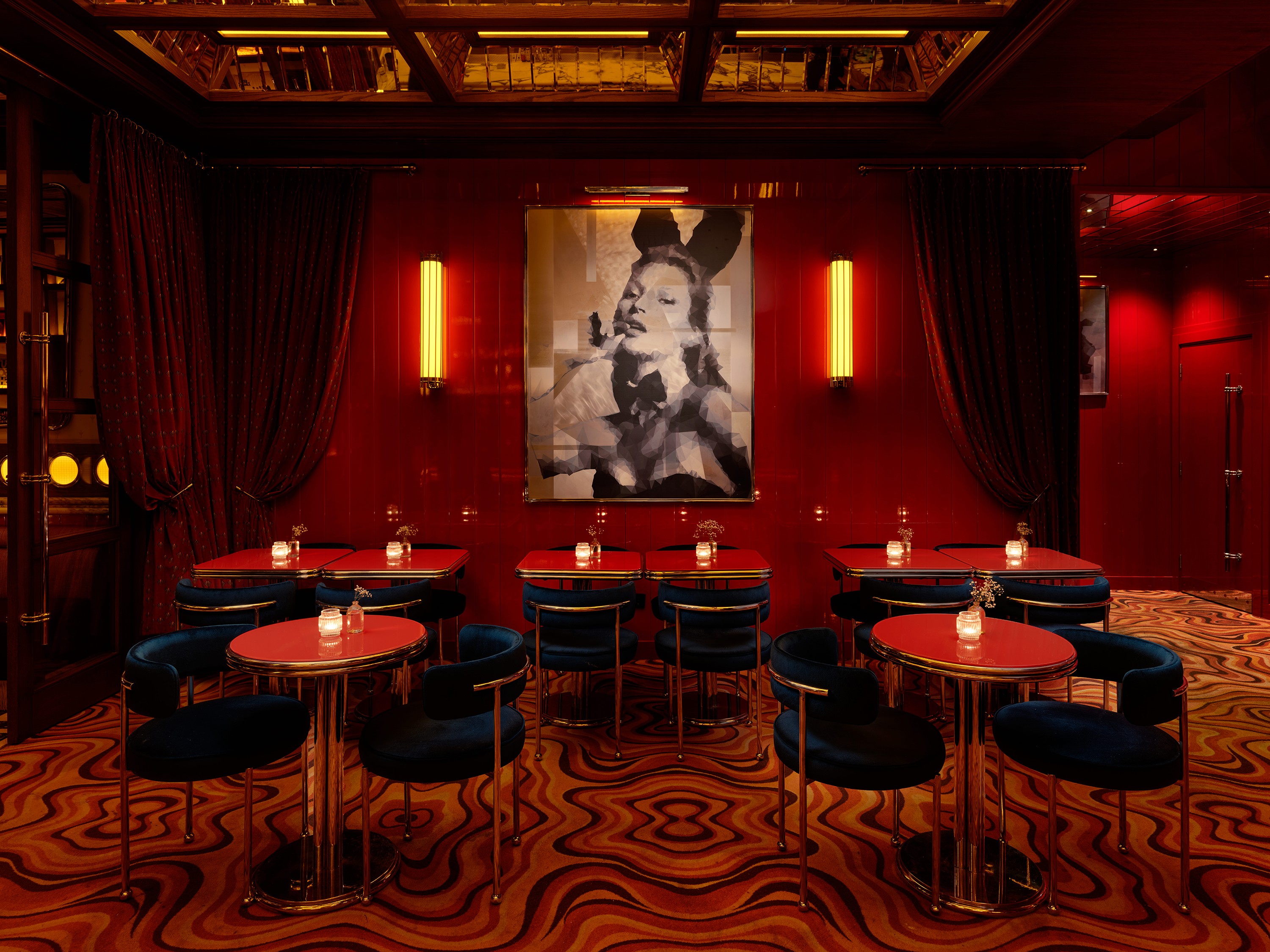 Modern terracotta architecture studio with curved ceilings, grid windows, round tables, stools, plants, and a contemporary chandelier.