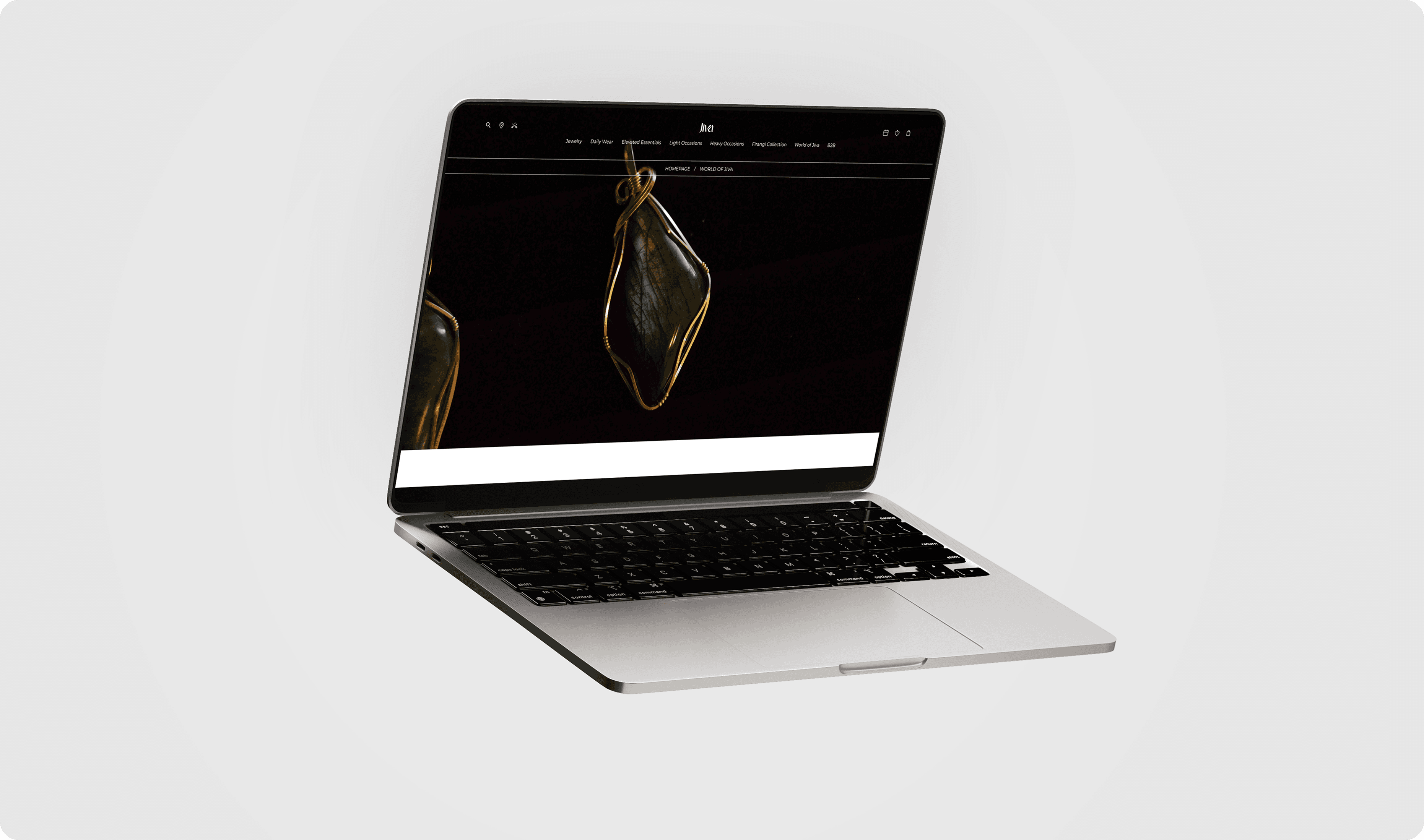 "Modern MacBook displaying Jiva Jewellery's website, featuring a striking pendant design with a labradorite gemstone in a gold wire wrap. The minimal, dark-themed interface highlights the elegance of handcrafted jewelry, appealing to customers seeking luxury and sophistication."
