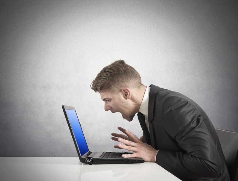 Businessman with blue screen of laptop error