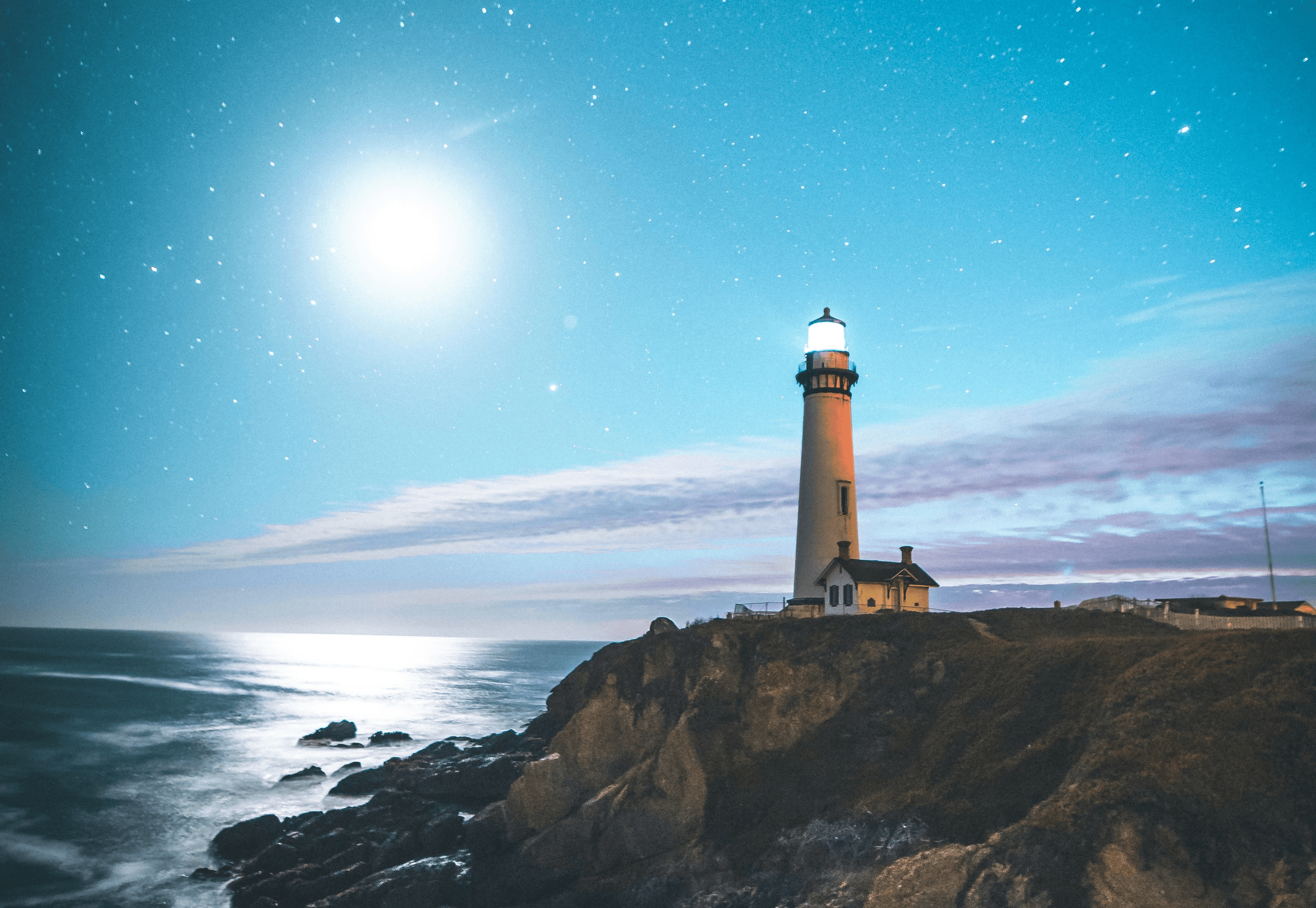 A group of people around the table with their laptops.