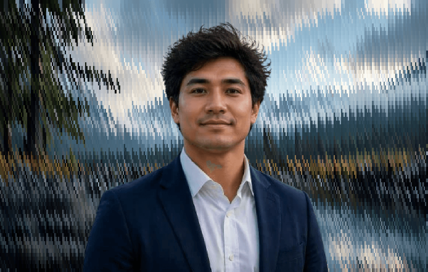 Professional portrait of a founding engineer in formal attire against a scenic background.