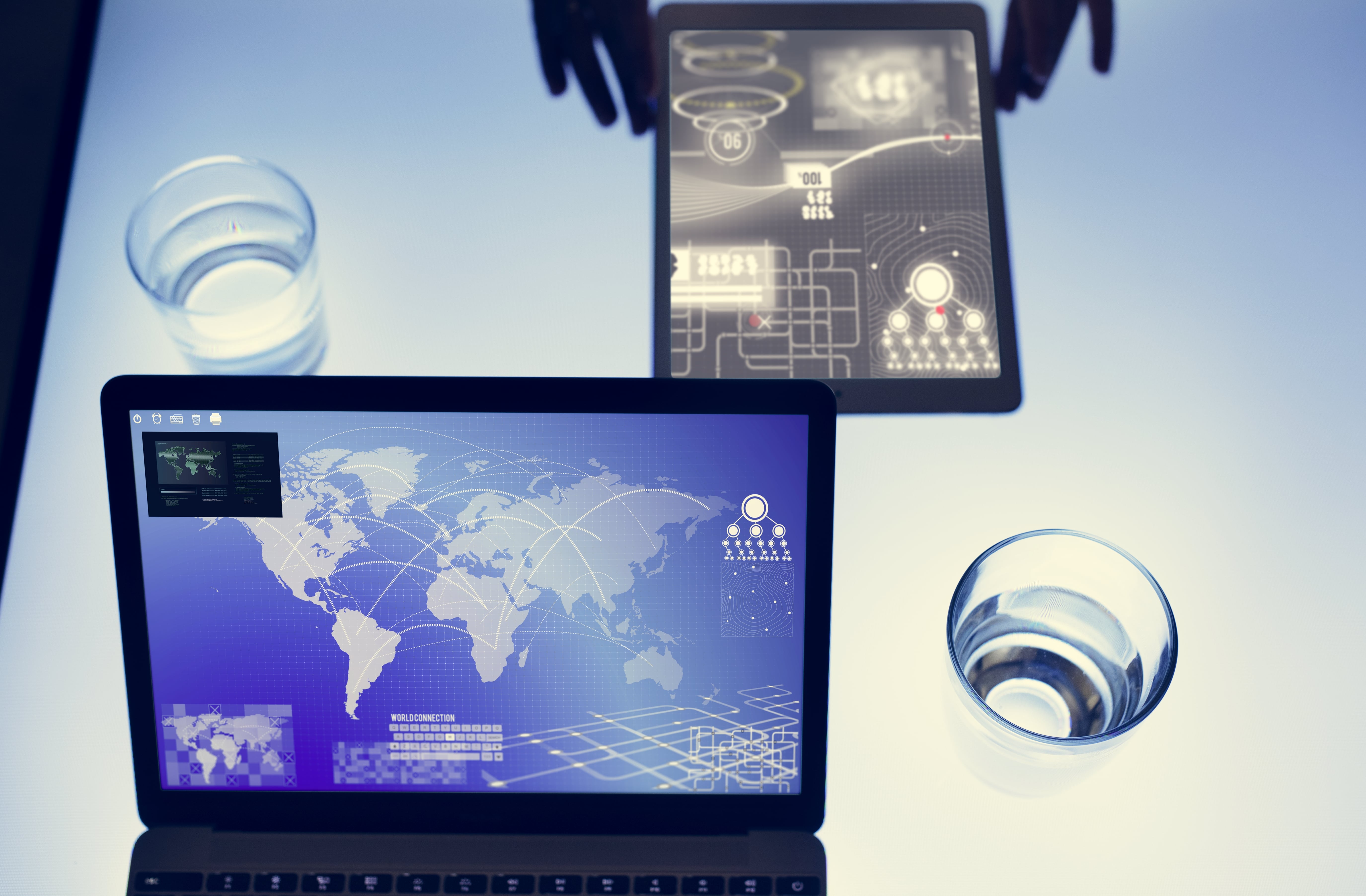 Futuristic data analysis on tablet and laptop with global network interface in cyber environment