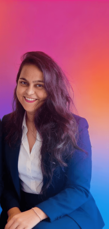 Portrait of a person in a pink sweater against a light background