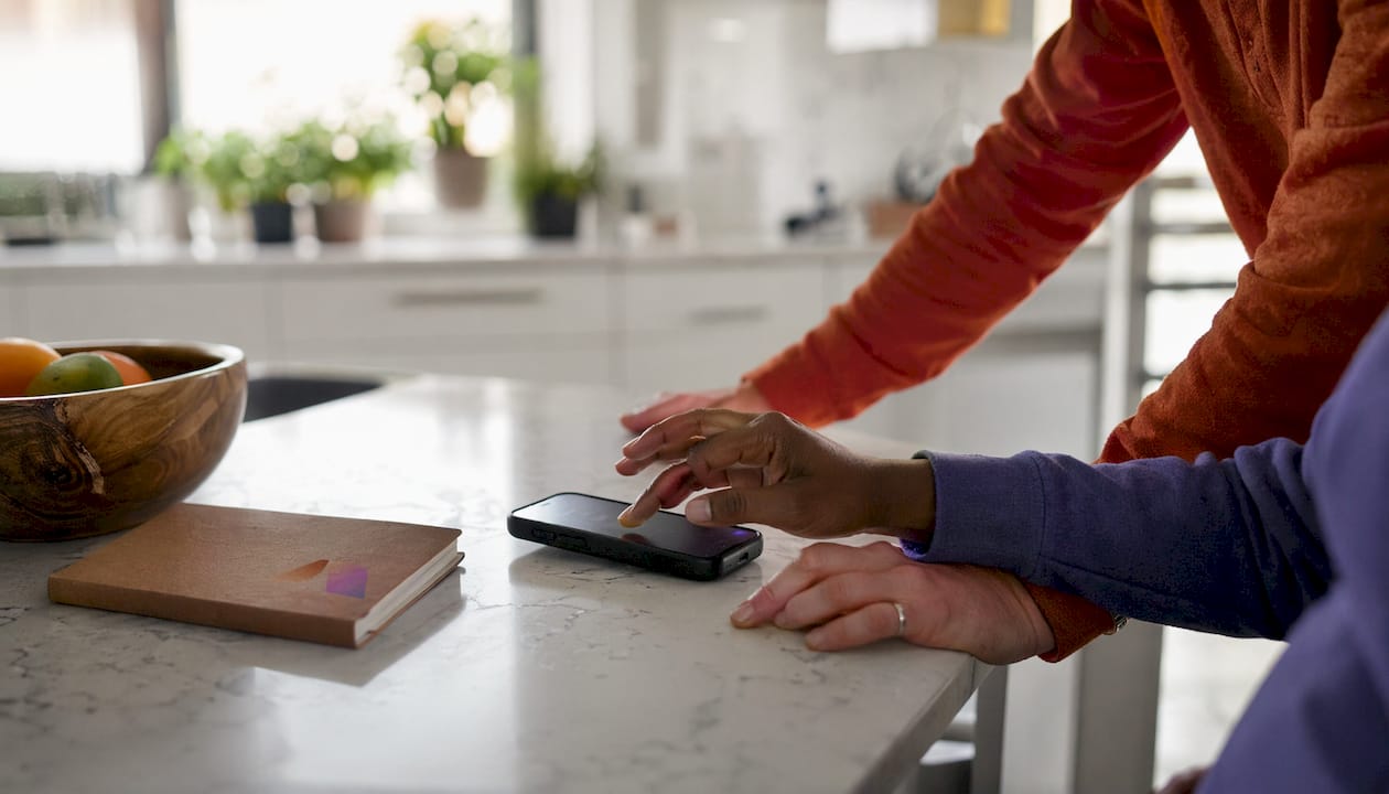 Hands interacting with phone for candidate chat