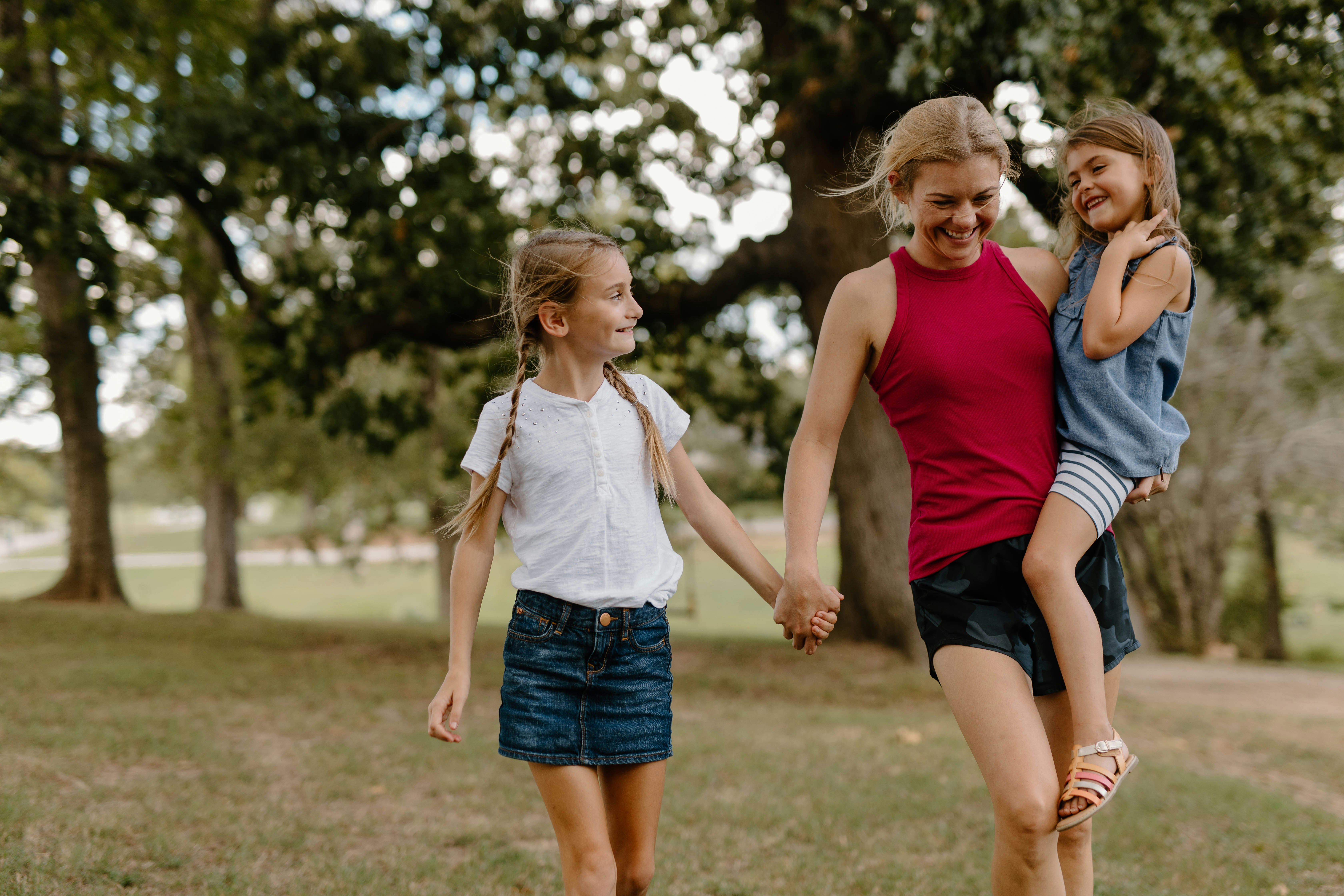 girl babysitting two youger children