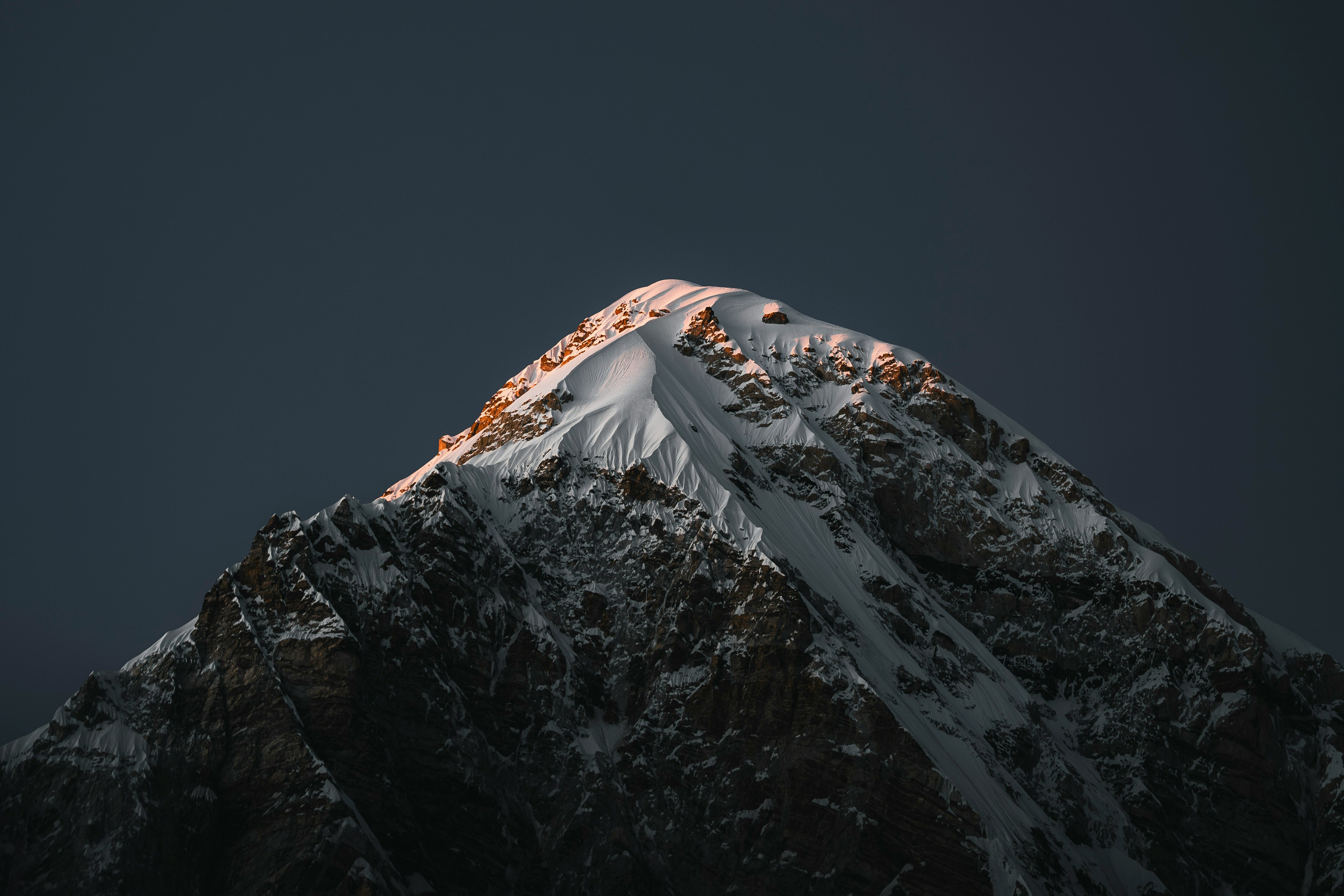 Sunlight illuminating a snow-covered mountain peak