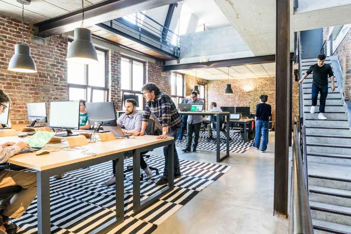People working on laptops in an indoor setting.