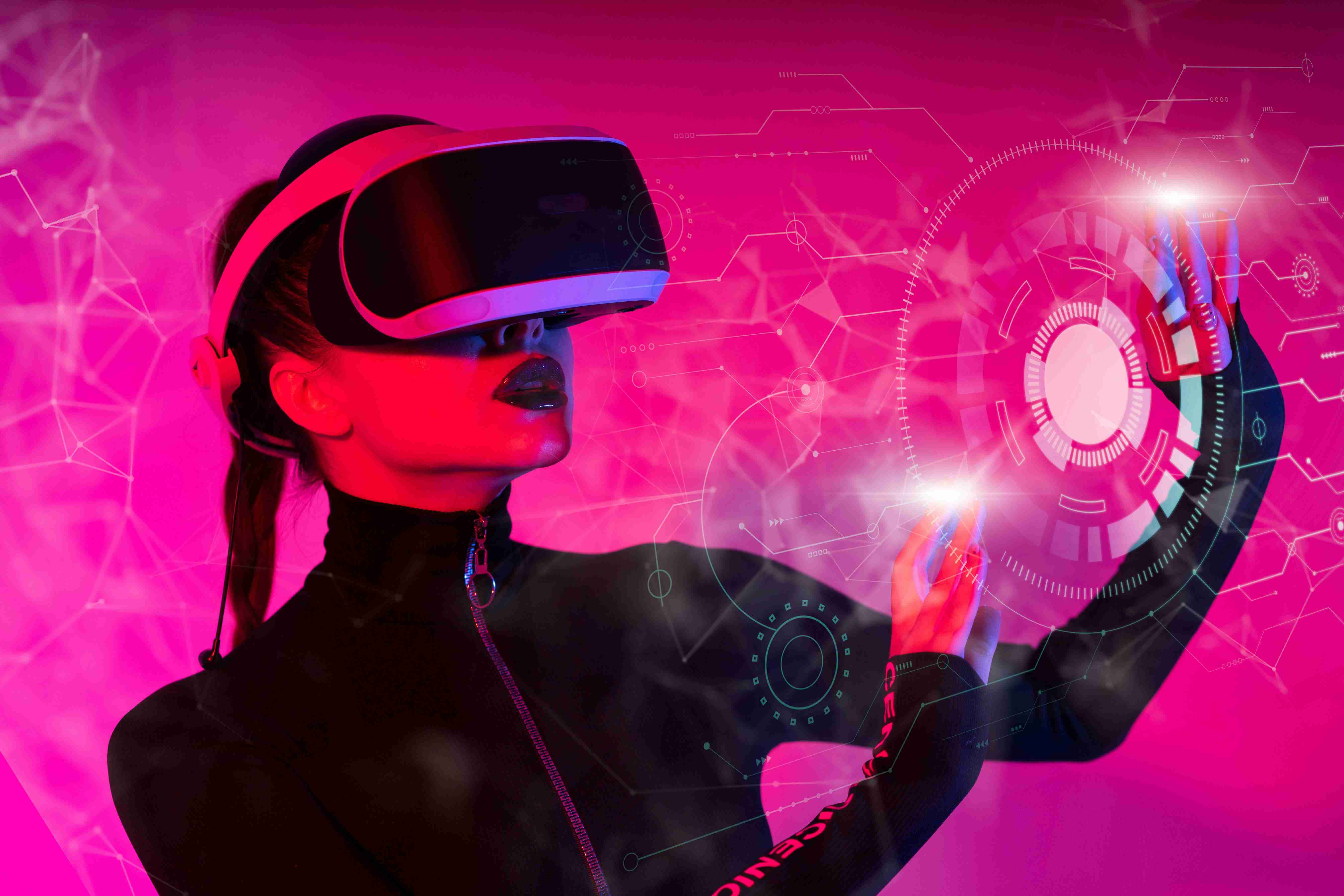 Woman exploring virtual reality with futuristic visuals in pink light