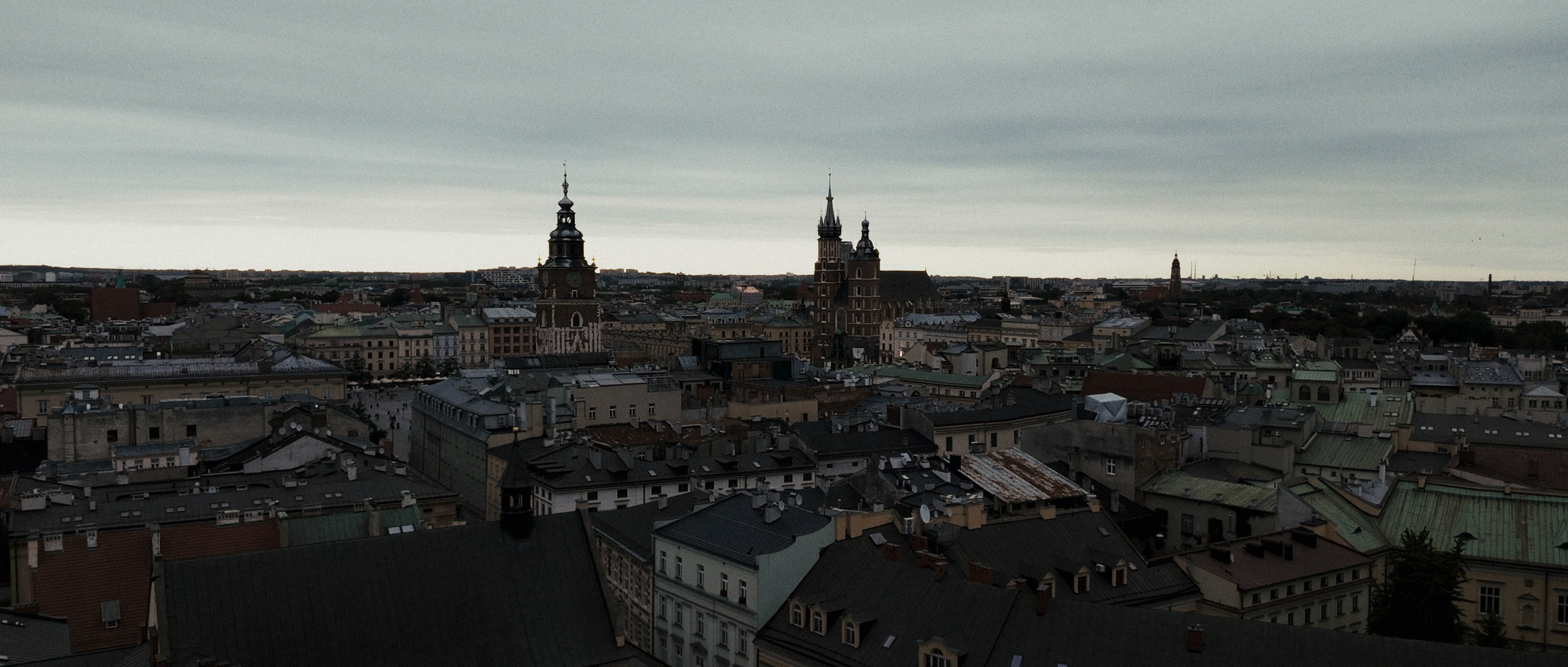 Wide establishing shot of Kraków rooftops and skyline for AST Academy anniversary commercial.