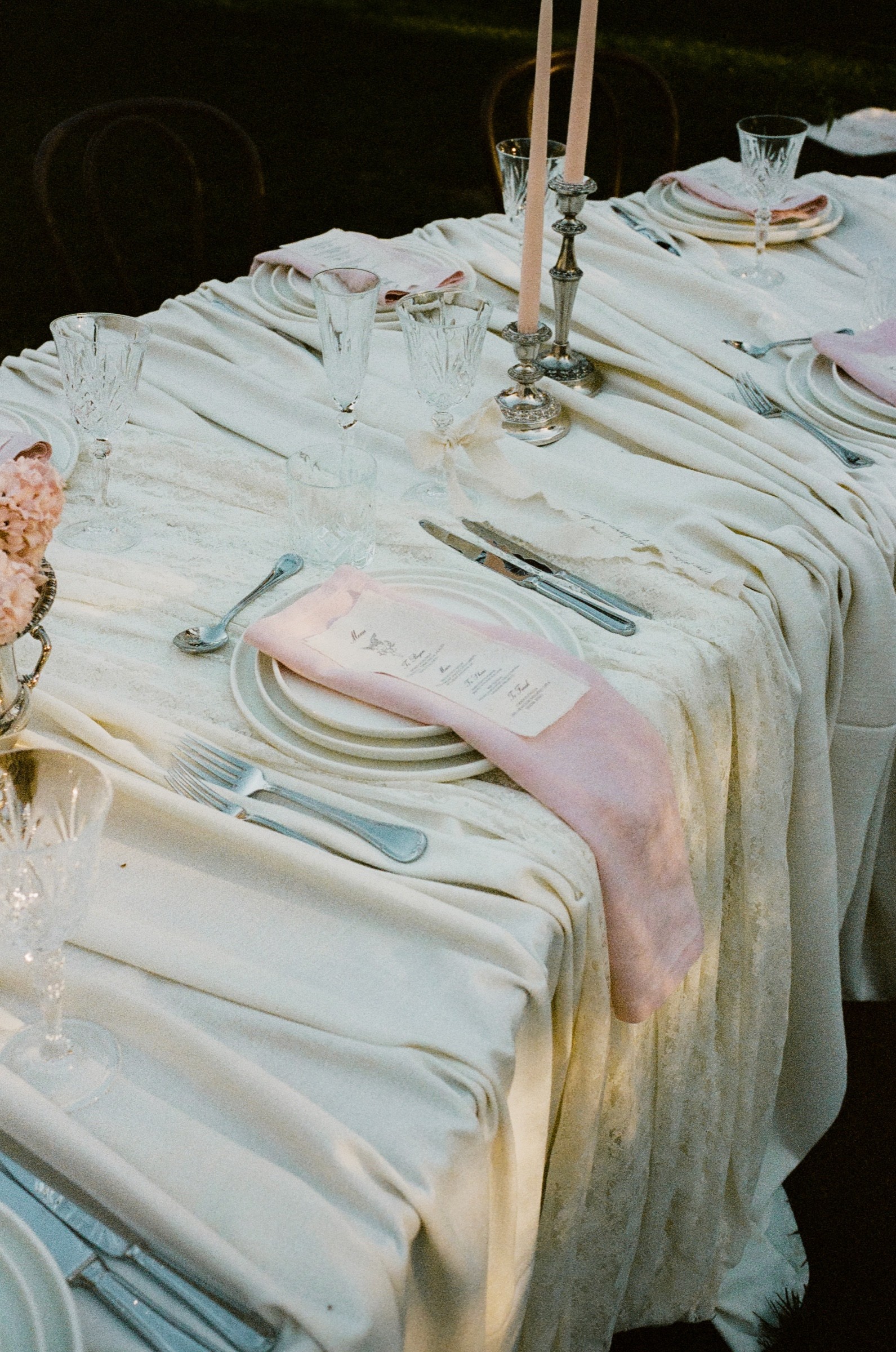 Pink linen, floral arrangement and tableware in an outdoor Mona Farm reception setting