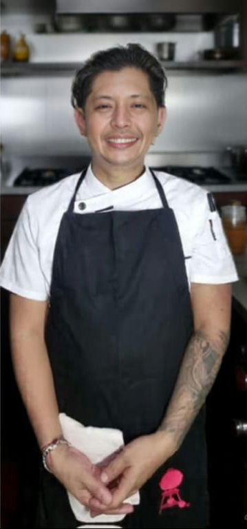 man in green crew neck shirt and black hat