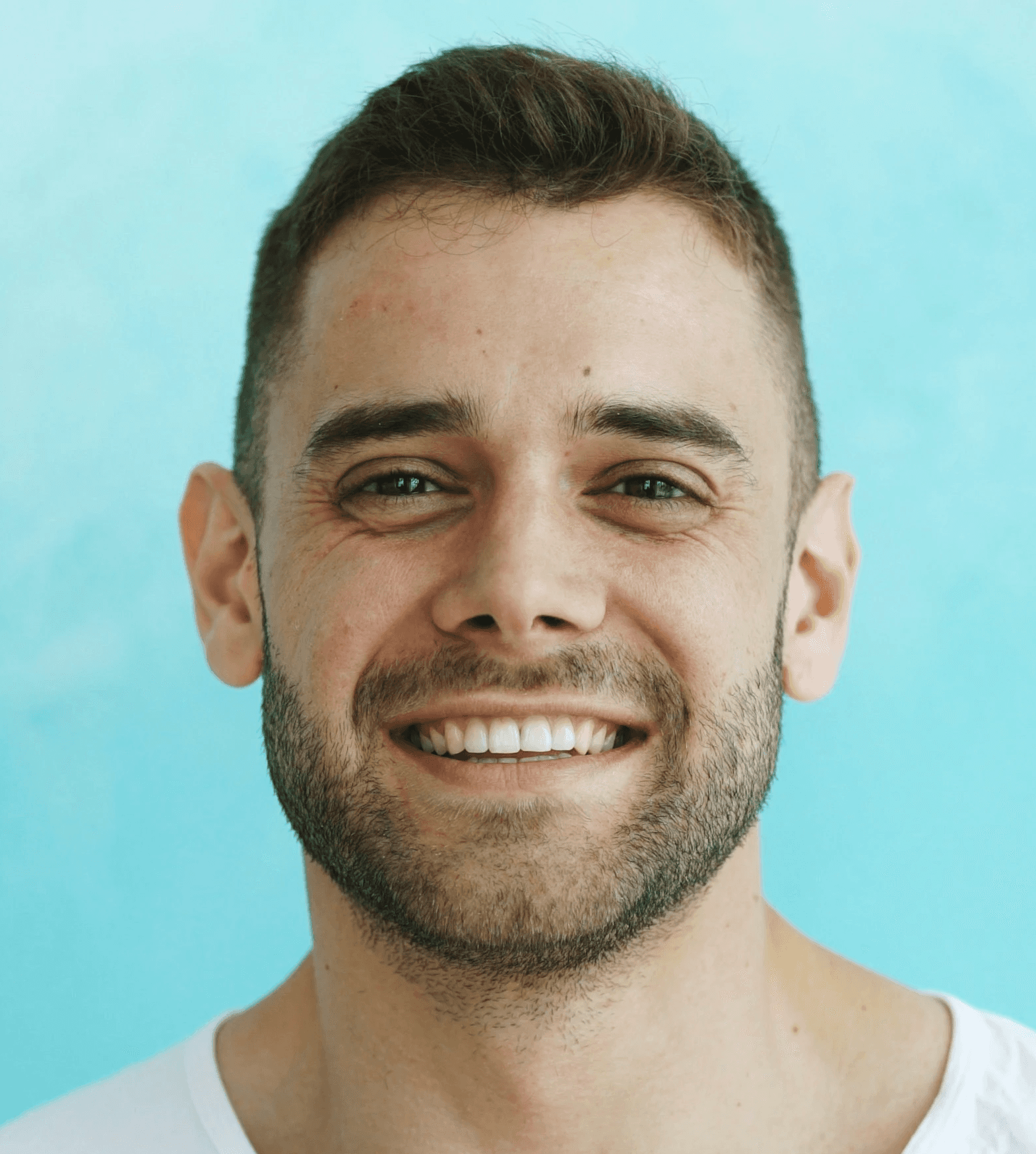A smiling man with short brown hair and beard.