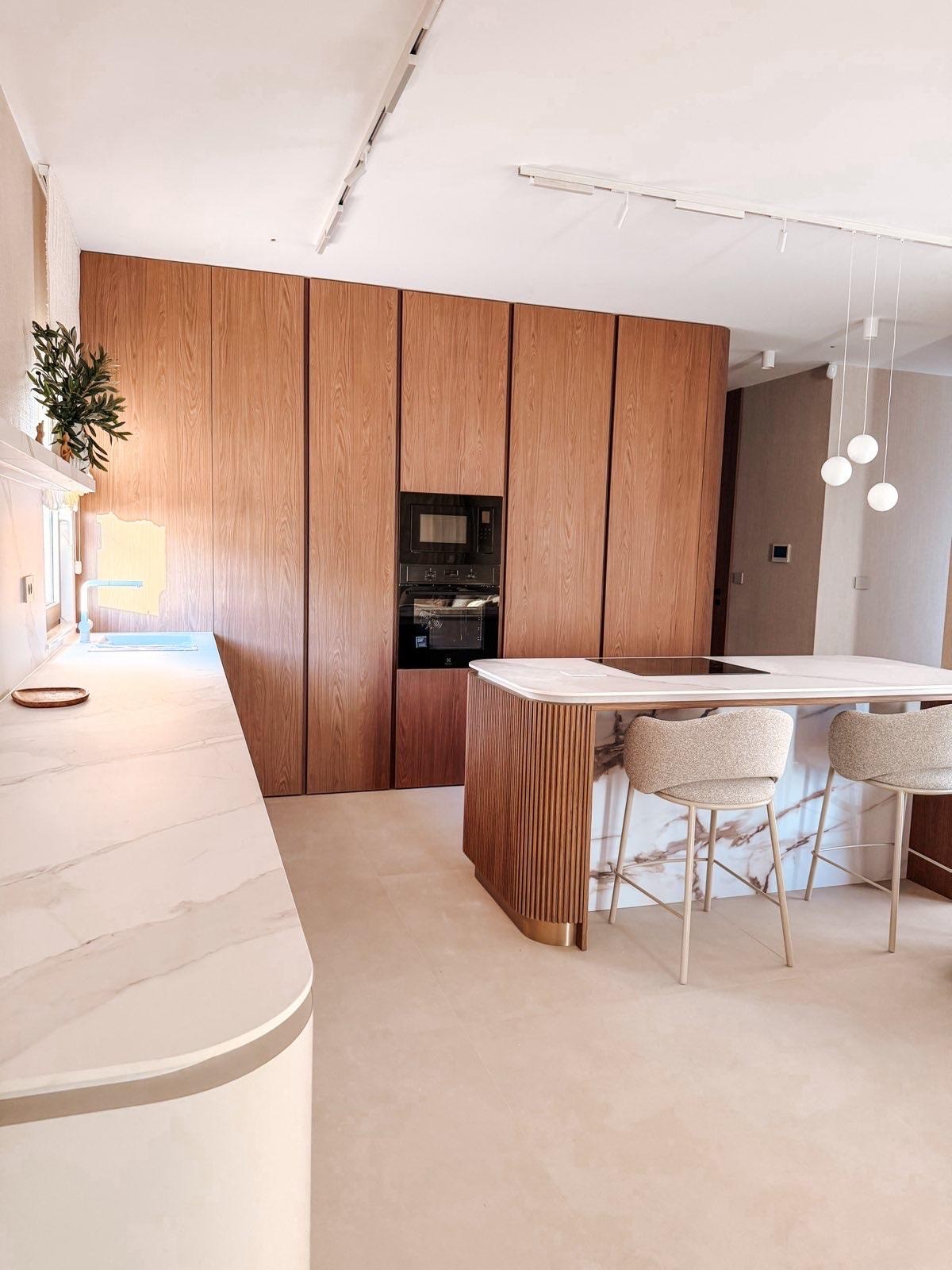 Black sports car in front of a modern, futuristic curved building.