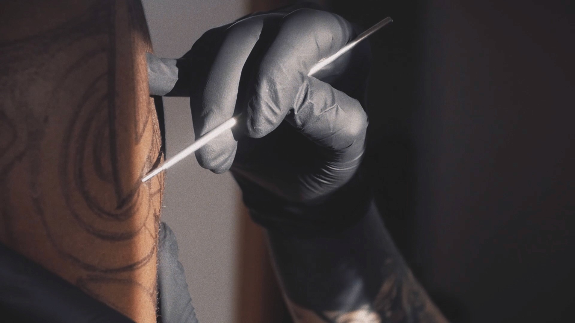 Cinematic art film frame close up of a freehand tattoo drawing process