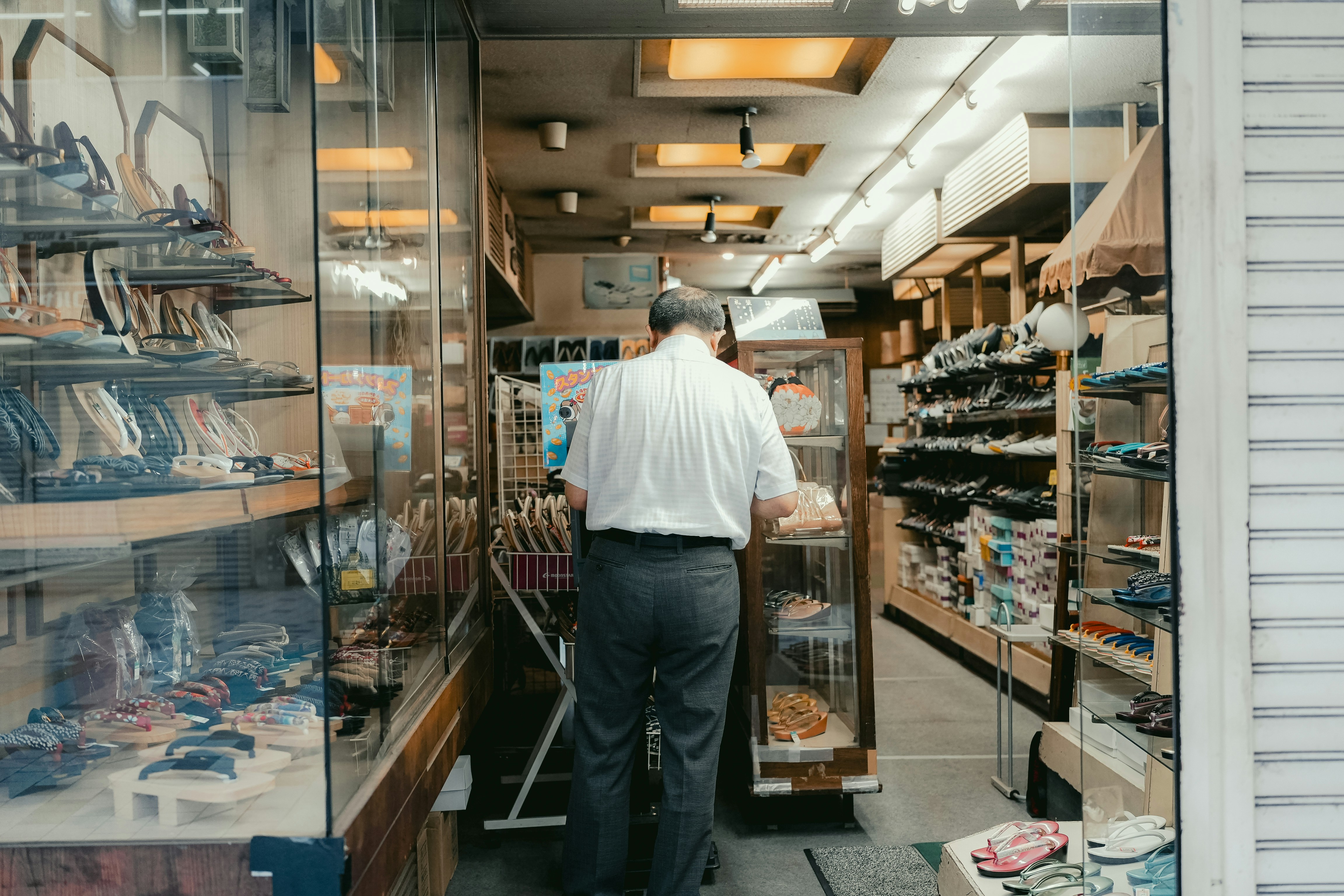 Man shopping in a well-stocked convenience store.