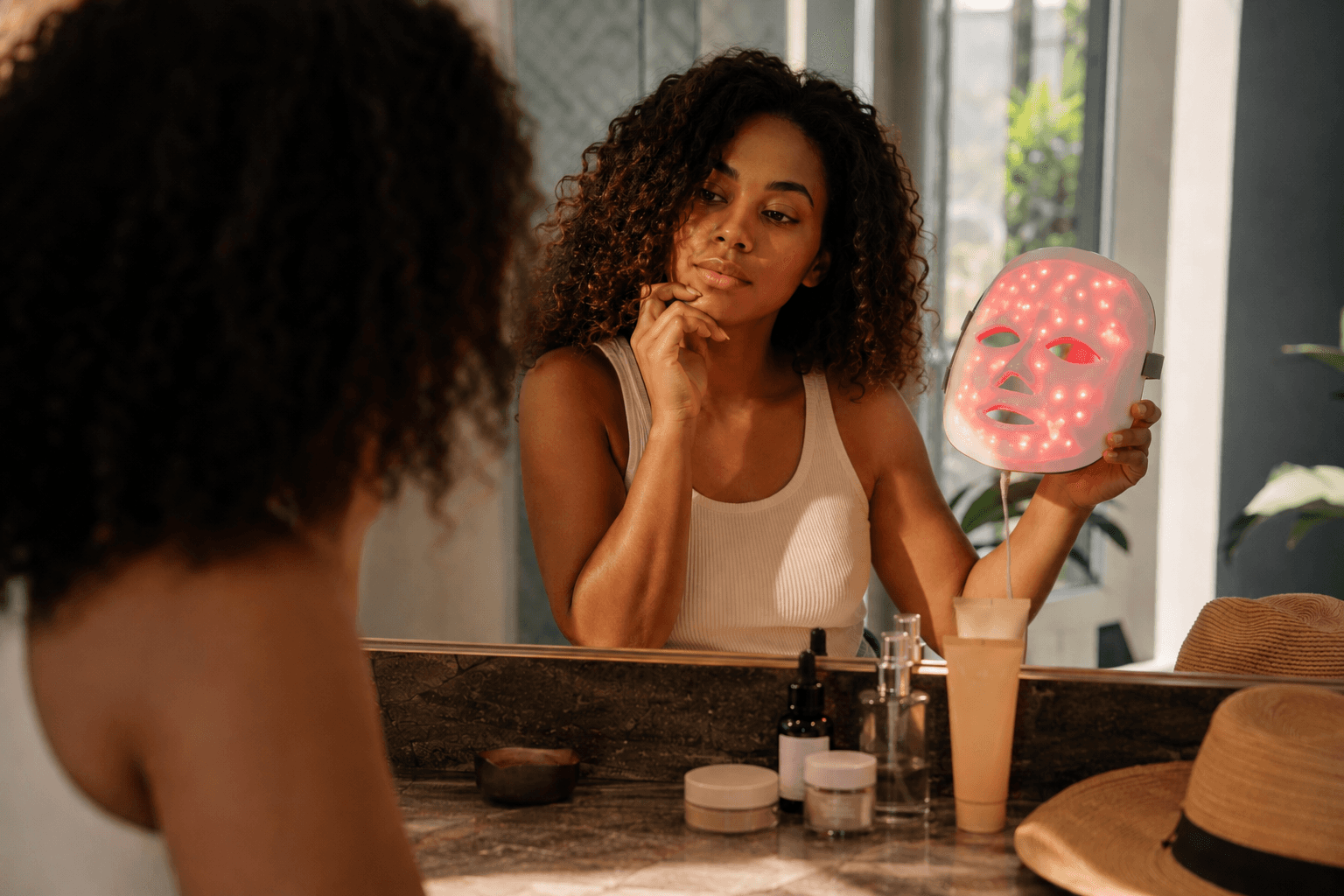 Sunscreen products, tinted SPF swatches, lip SPF, and a hat for sensitive-skin sun protection.