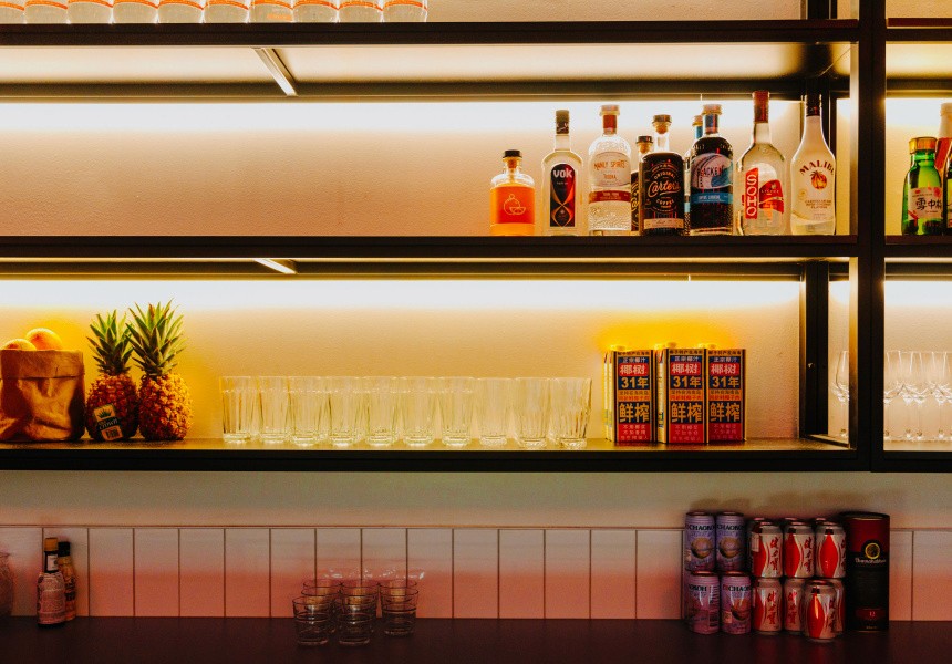 Illuminated wall shelving displaying folded garments, reflected in a full-height mirror within the Double Double interior.