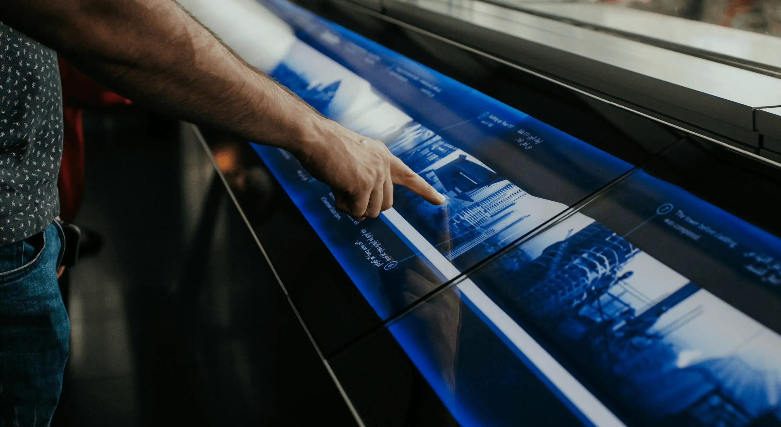 Person interacting with a touchscreen display.