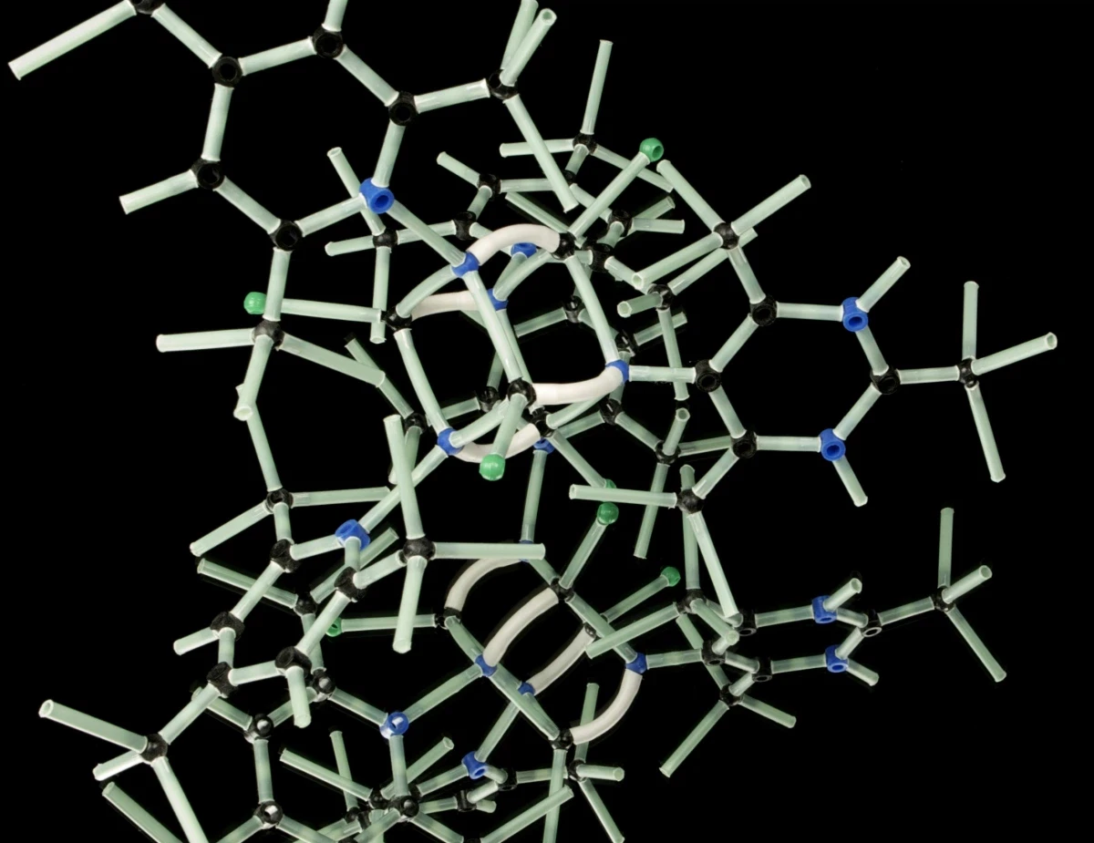 white plastic wire puzzle with black background