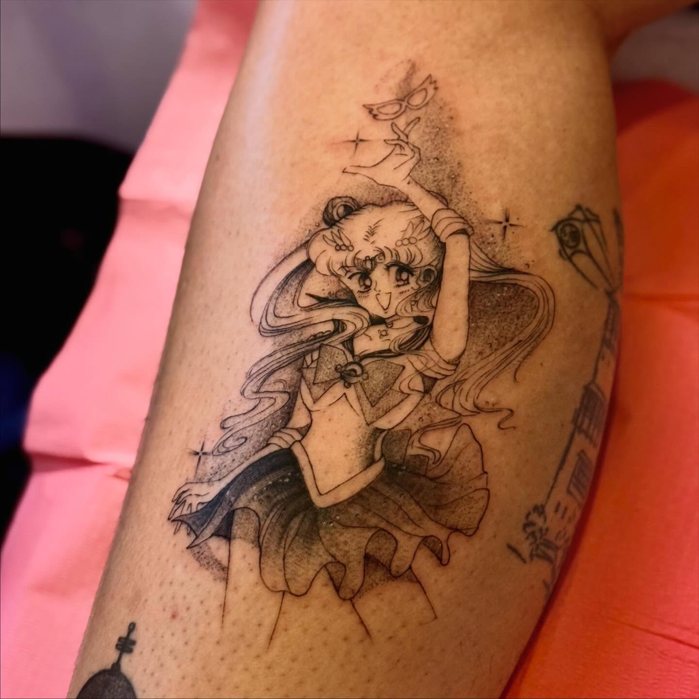 A forearm tattoo of Nezuko Kamado from Demon Slayer, depicted in a stylized anime art style. She is holding a sword.