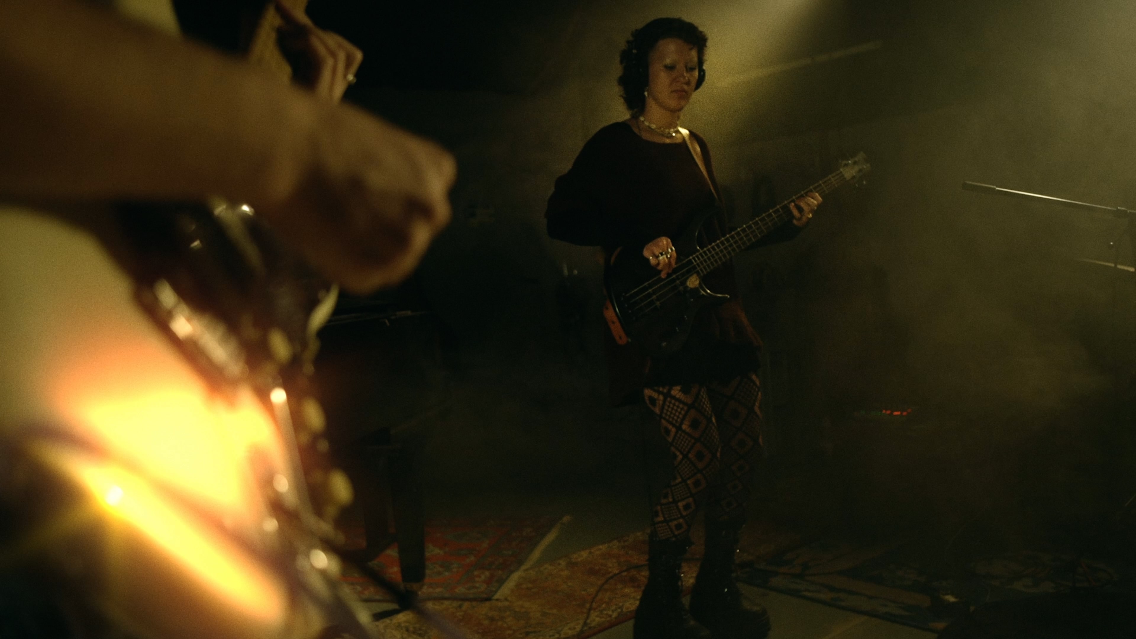 guitar infron and girl with bass