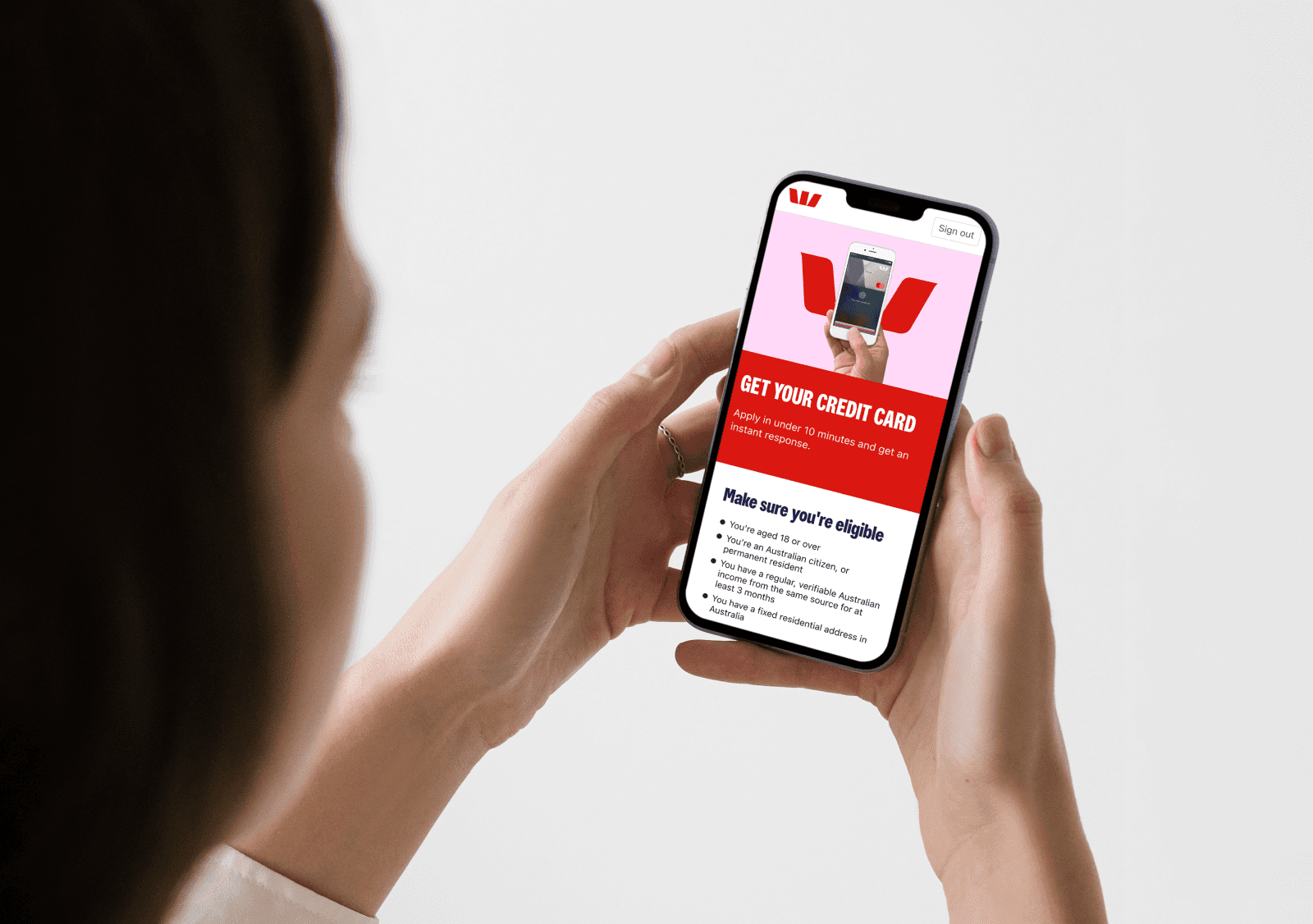 Woman holding phone looking to start application
