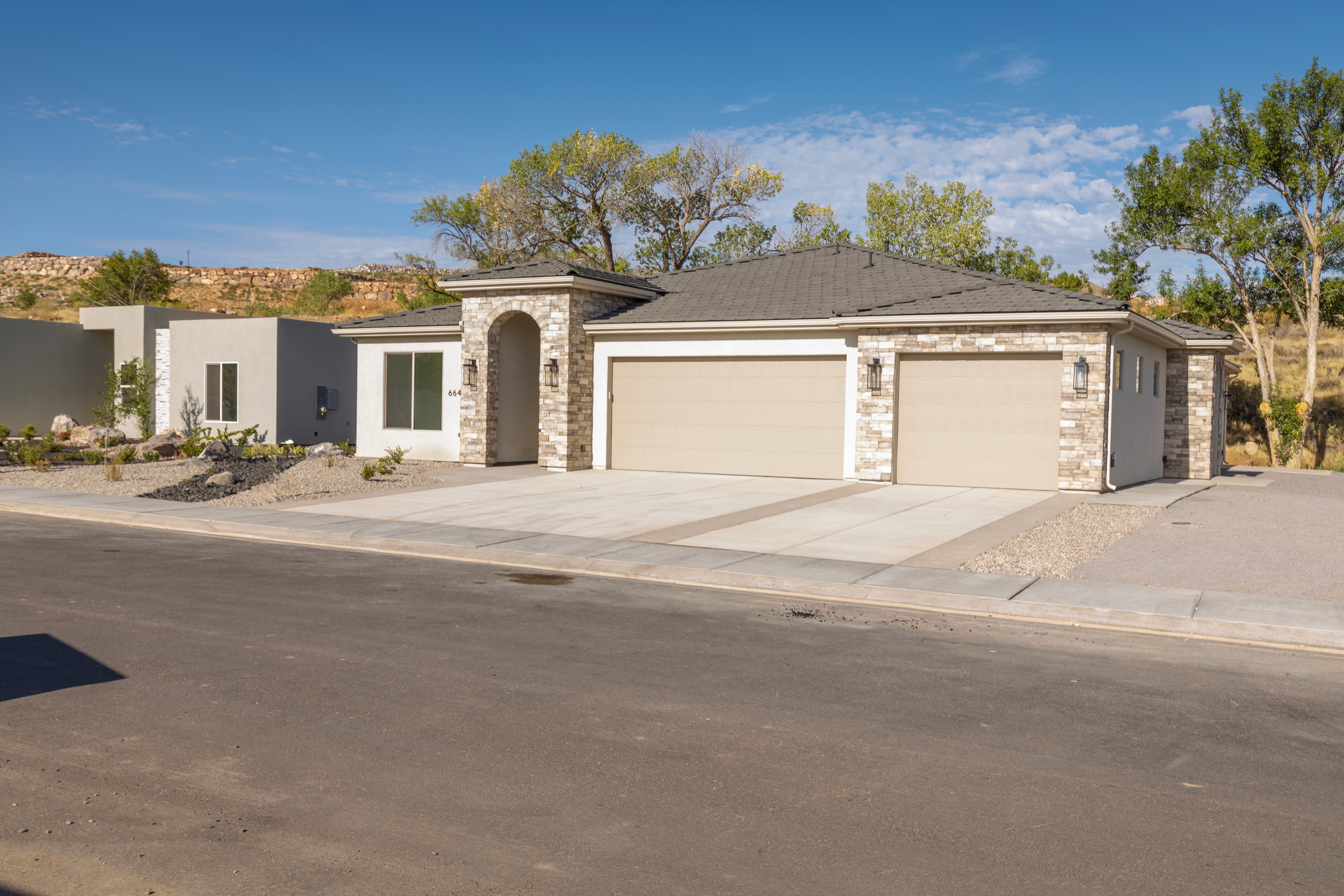 Exterior view of Mountain View’s Cove showcasing bright curb appeal and thoughtfully designed landscaping in a Southern Utah home.