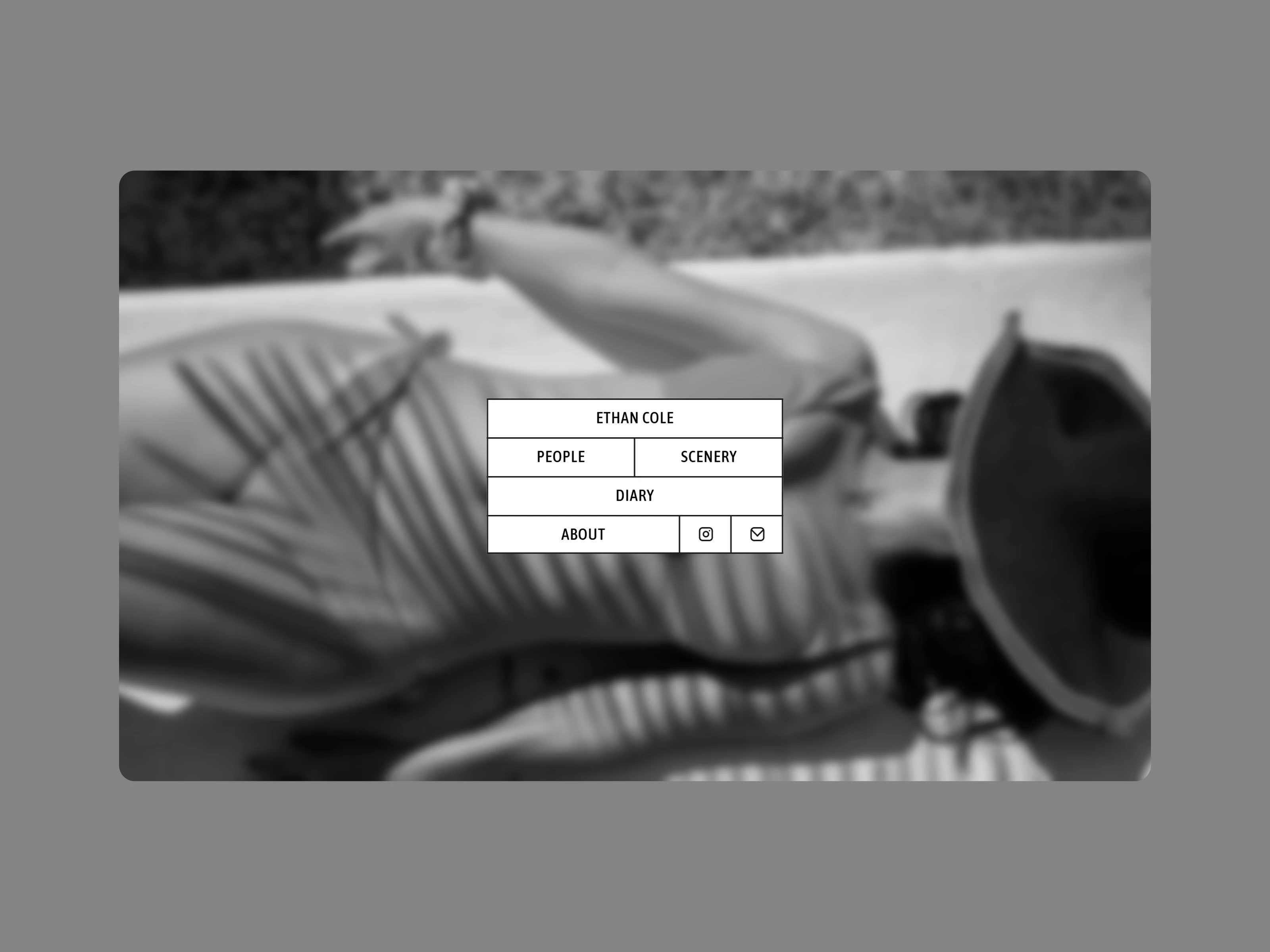 Minimal photographer portfolio with blurred background and centered navigation menu