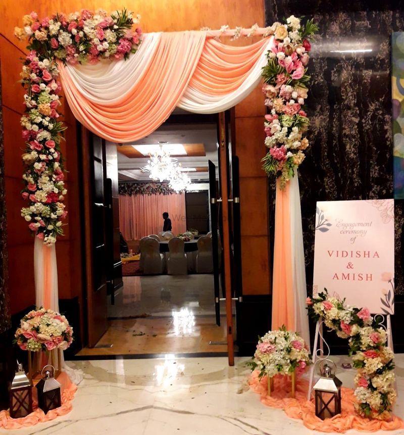 Wedding entrance gate decor with peach drapes & flowers, ideal for outdoor home or banquet entrance in Pitampura, Ashok Vihar