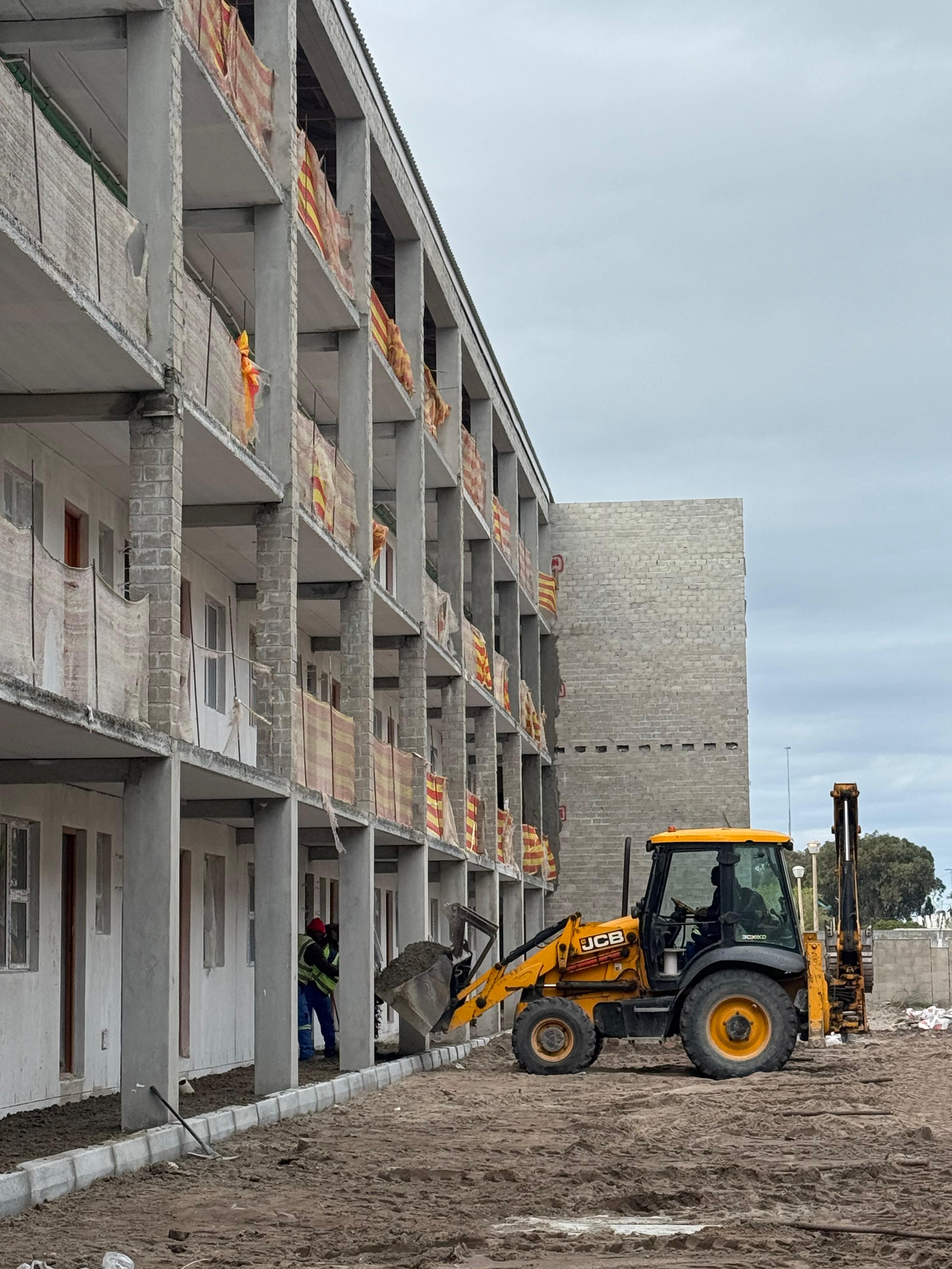 black and white building with yellow crane
