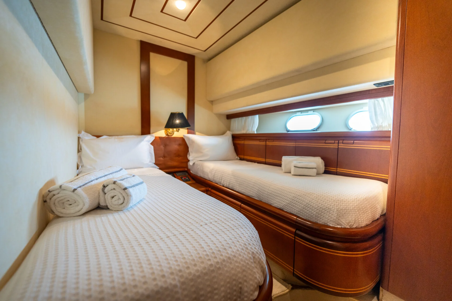 White Rock 36 speedboat with captain at helm cruising calm blue waters near Paros coastline with hills in background.