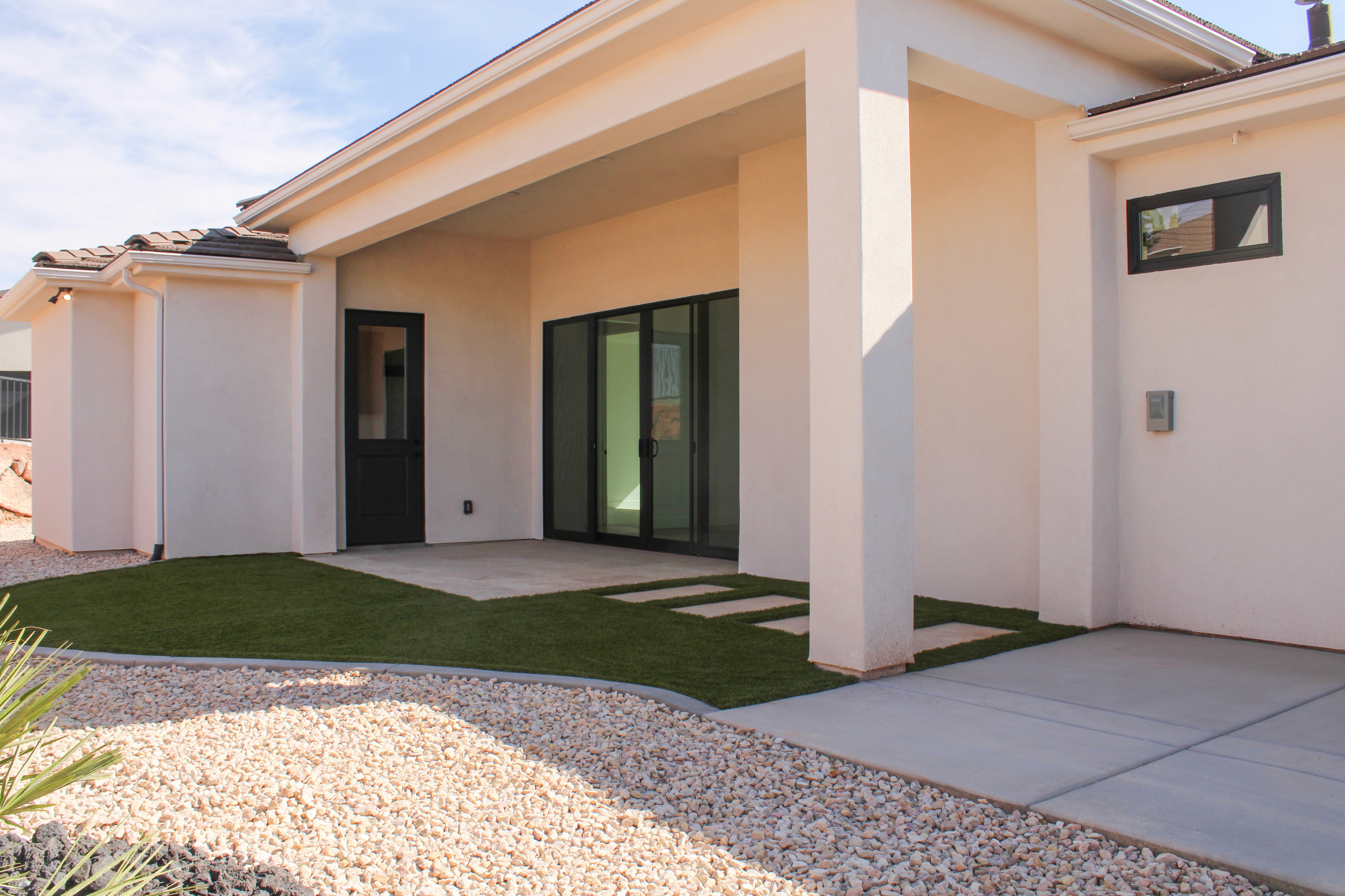 Patio and backyard of The Overlook at Falcon Ridge in Hurricane, Utah, showing outdoor seating areas and terraced landscaping.