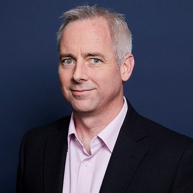 a man in a suit posing for a picture