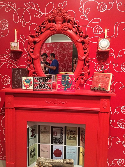 mirror over red fireplace