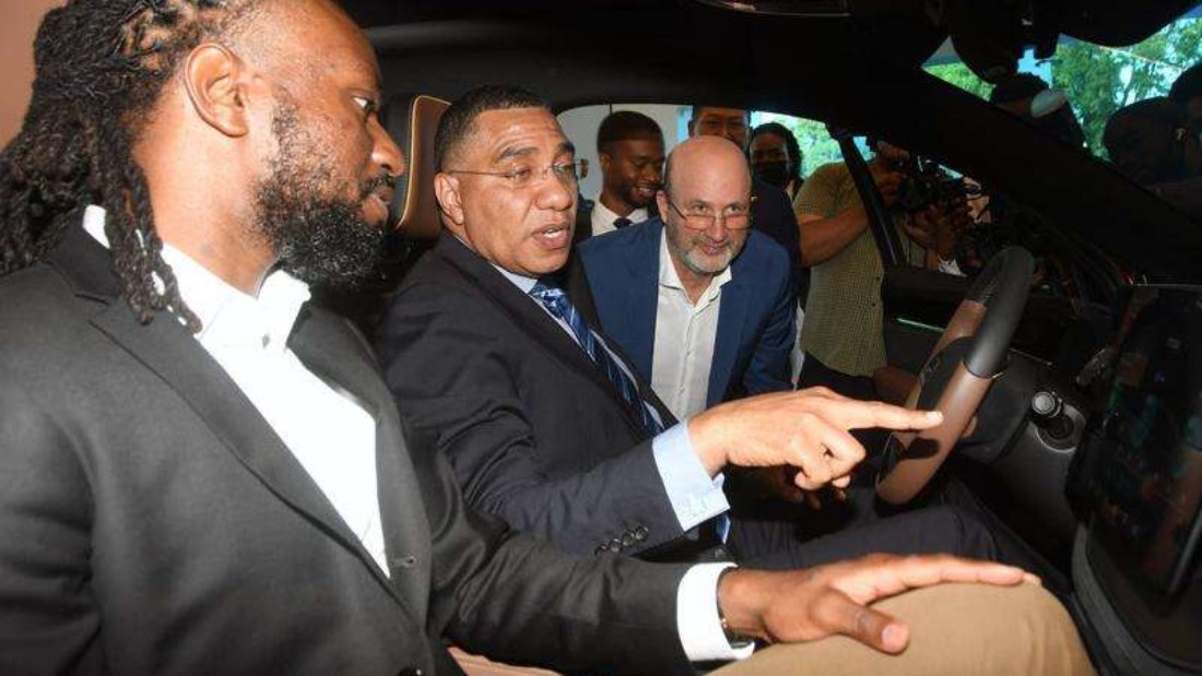 Cofounder Xavier with Prime Minister Andrew Holness looking at an EV