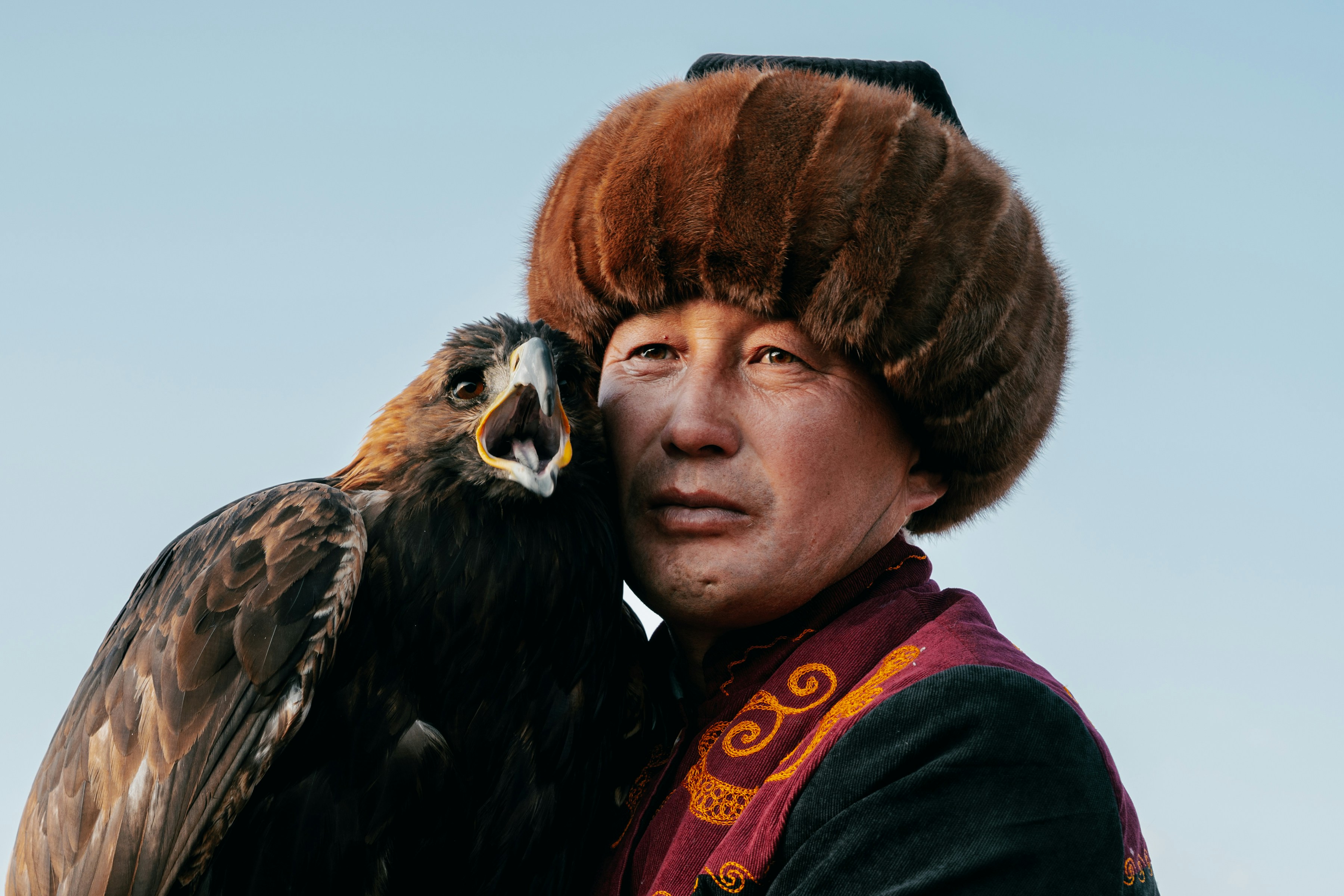 Man with fur hat and eagle.
