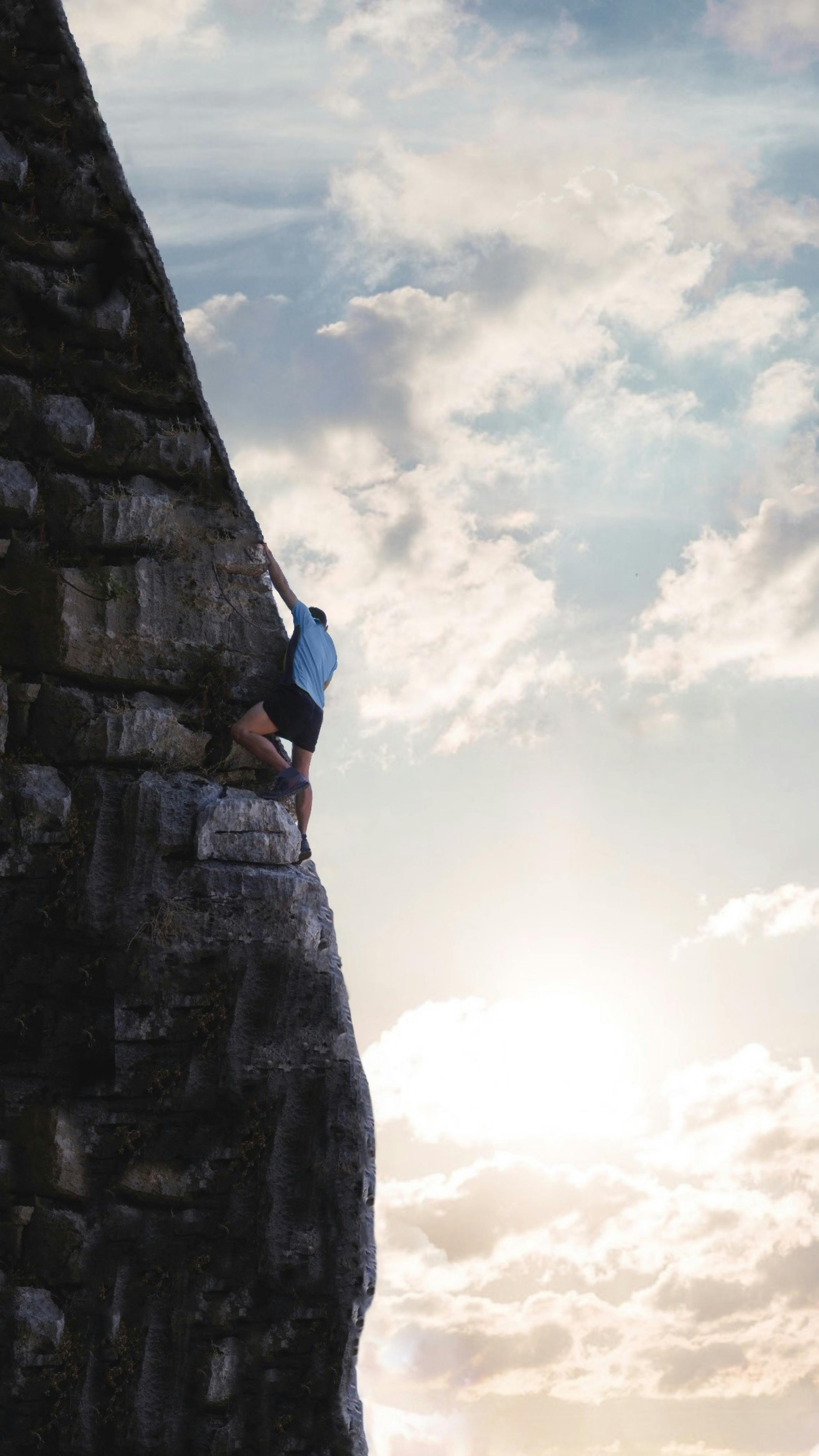 a-man-climbing-a-steep-rocky-mountain-against-a-sunrise-backdrop-symbolizing-det - b-pixels (pexels)